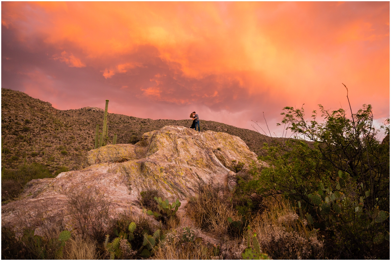 Couple embracing during their anniversary adventure session in Saguaro National Park at sunset. | Clarissa Wylde Photography