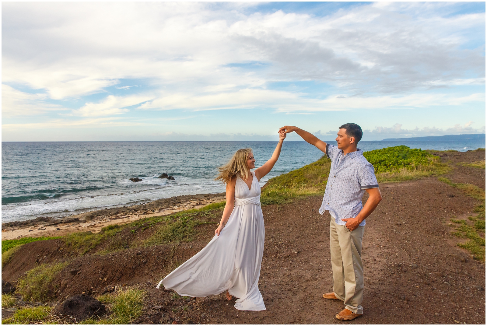 Couple dancing on the beach during their Hawaiian destination wedding.