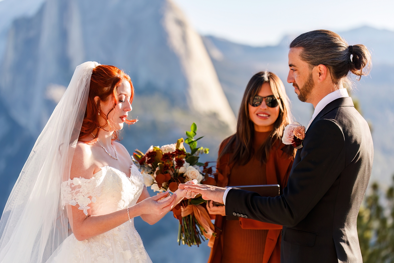 this bride and groom are exchanging rings during their glacier point elopement 