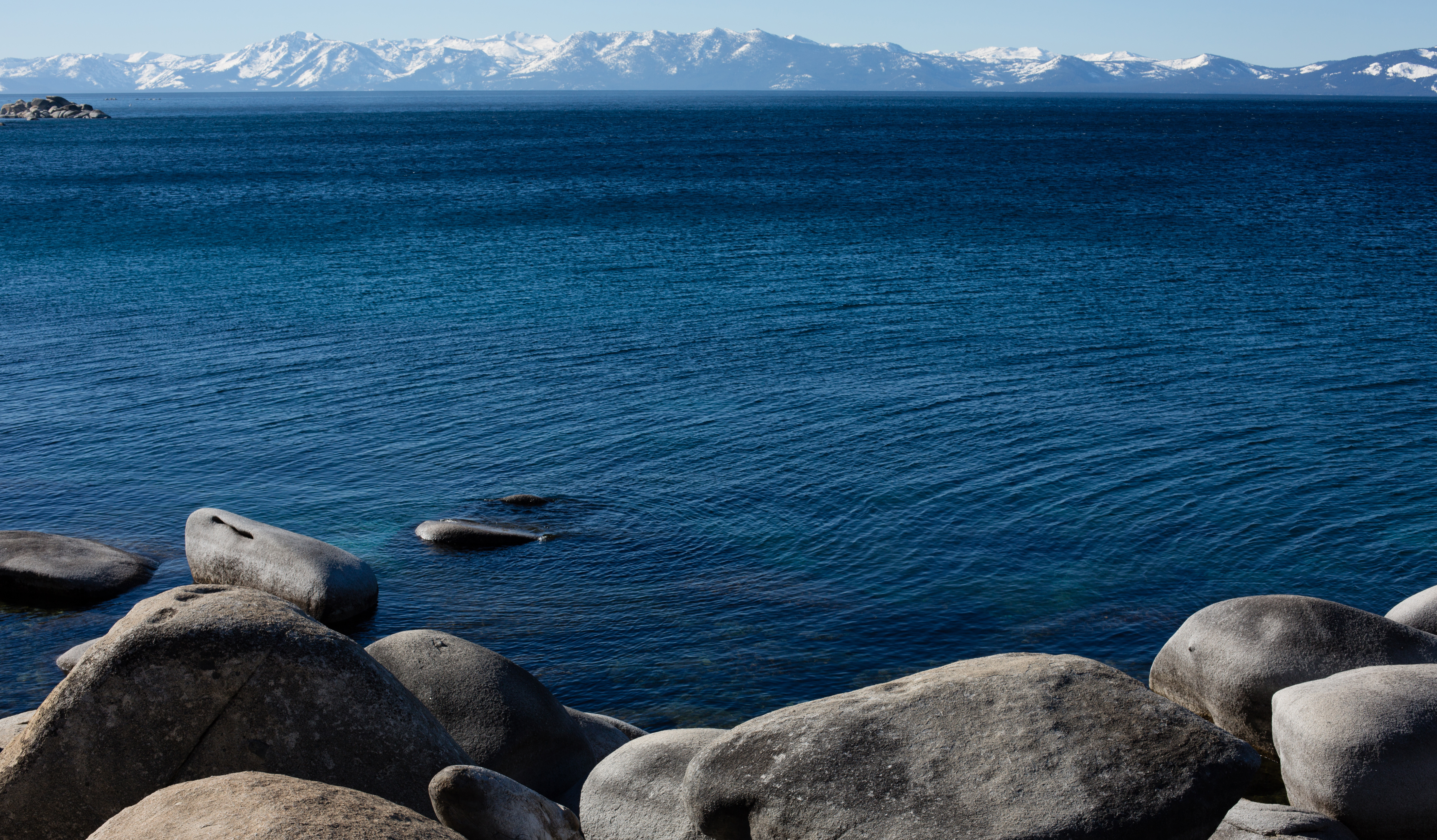 Lake Tahoe's brilliant blue waters and rocky east shore in the afternoon.