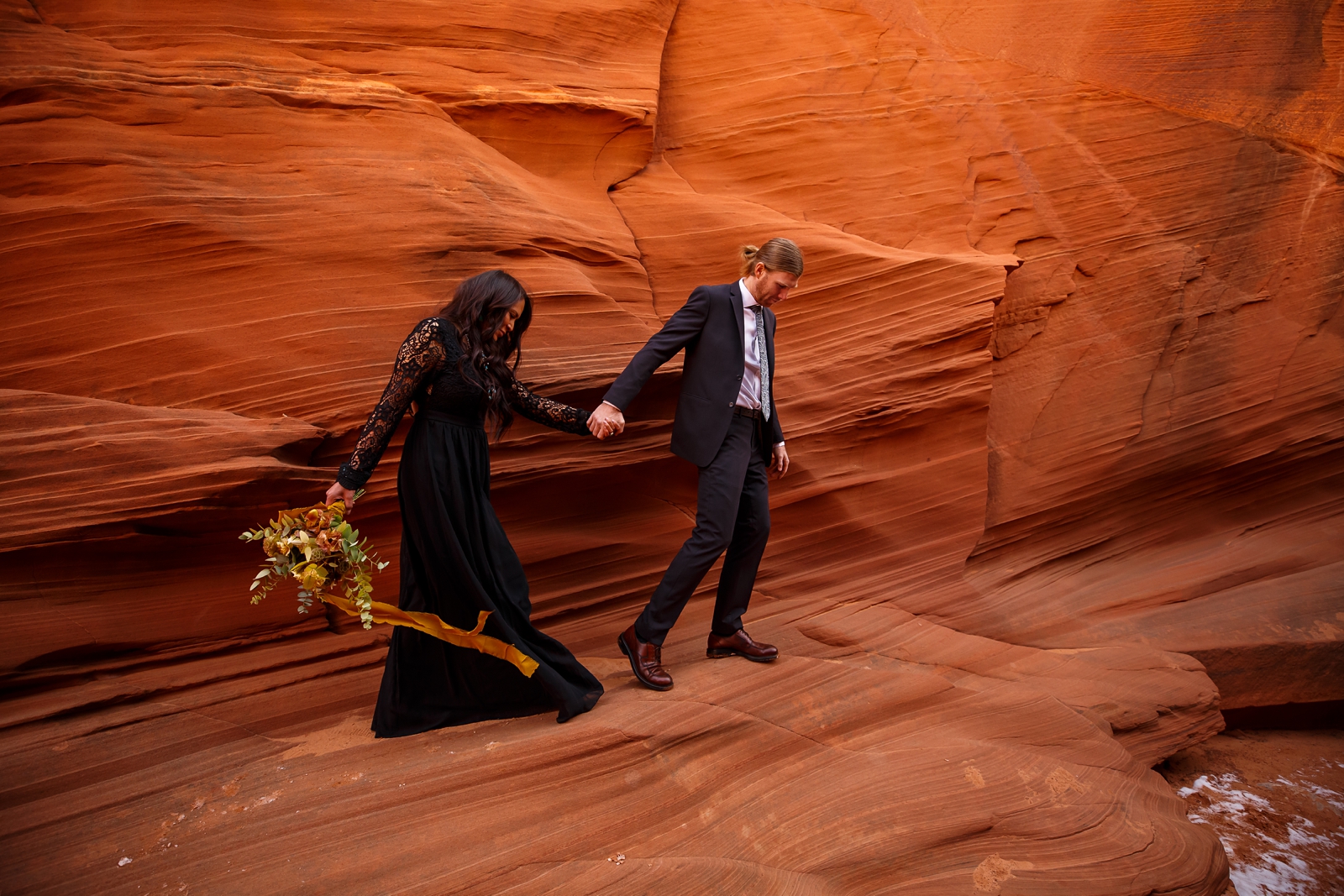 This couple is adventuring in a slot canyon.