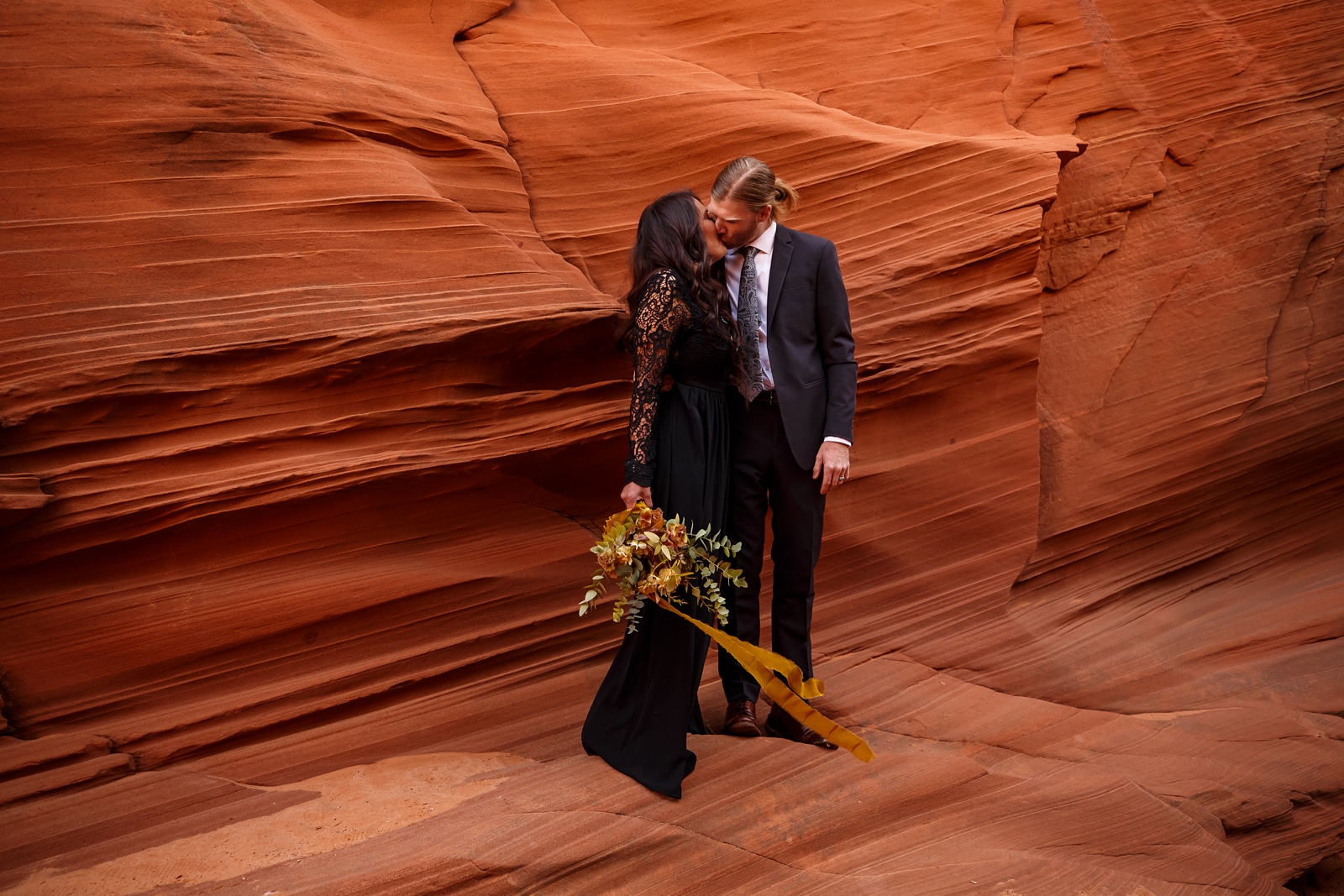 Couple kissing in an Arizona slot canyon.