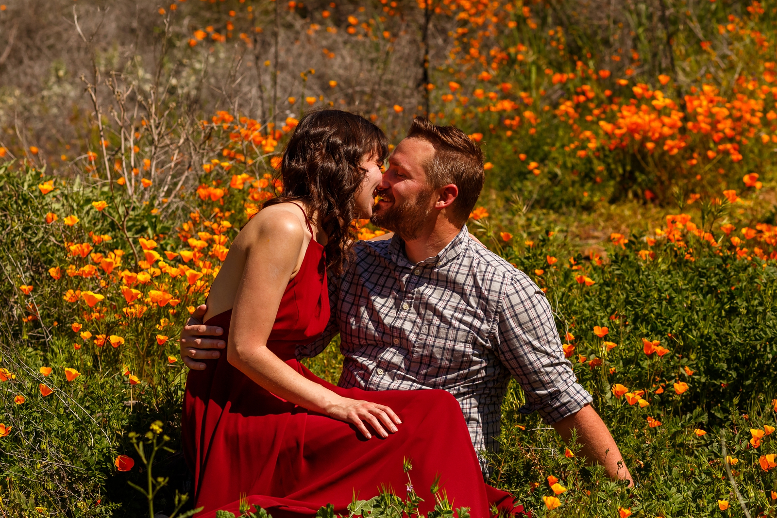 Engaged couple kissing in the spring