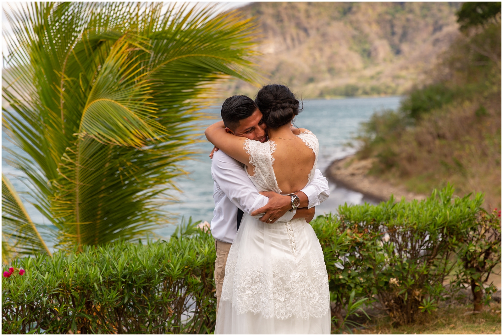 A couple hugging after their intimate first look on a lake.