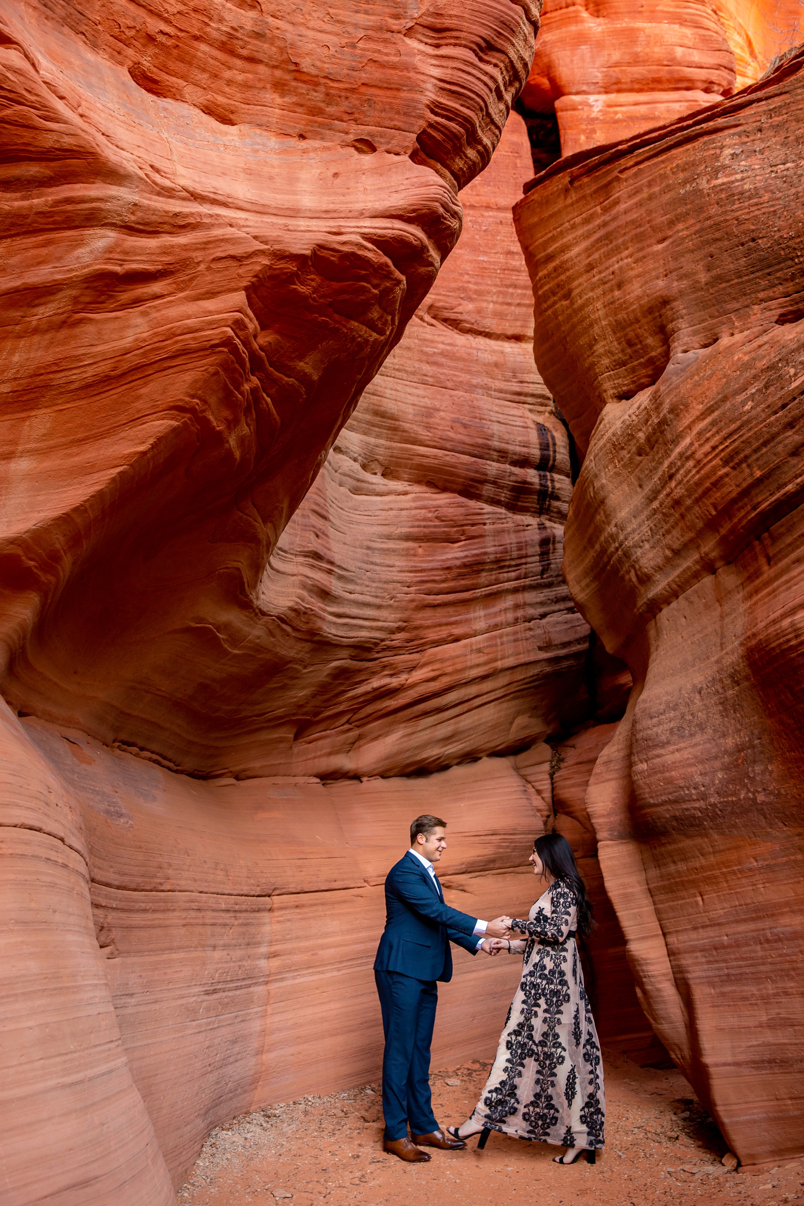 Playful couple in a Utah slot canyon.