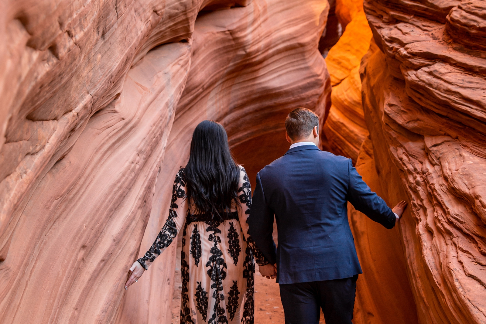 Engaged couple exploring a Utah slot canyon.