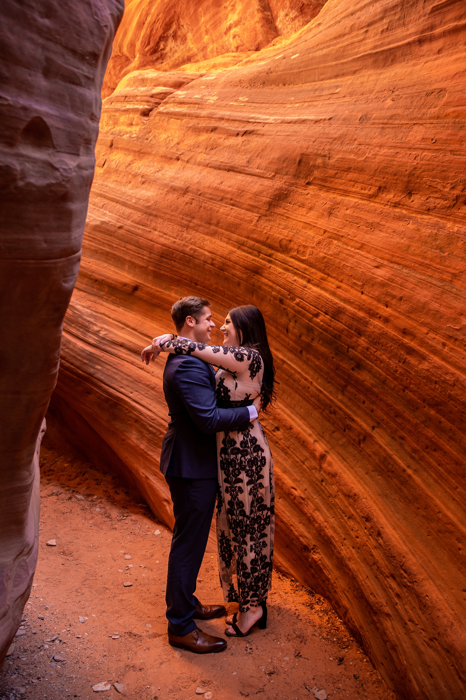 Couple in love in a glowing Utah slot canyon.