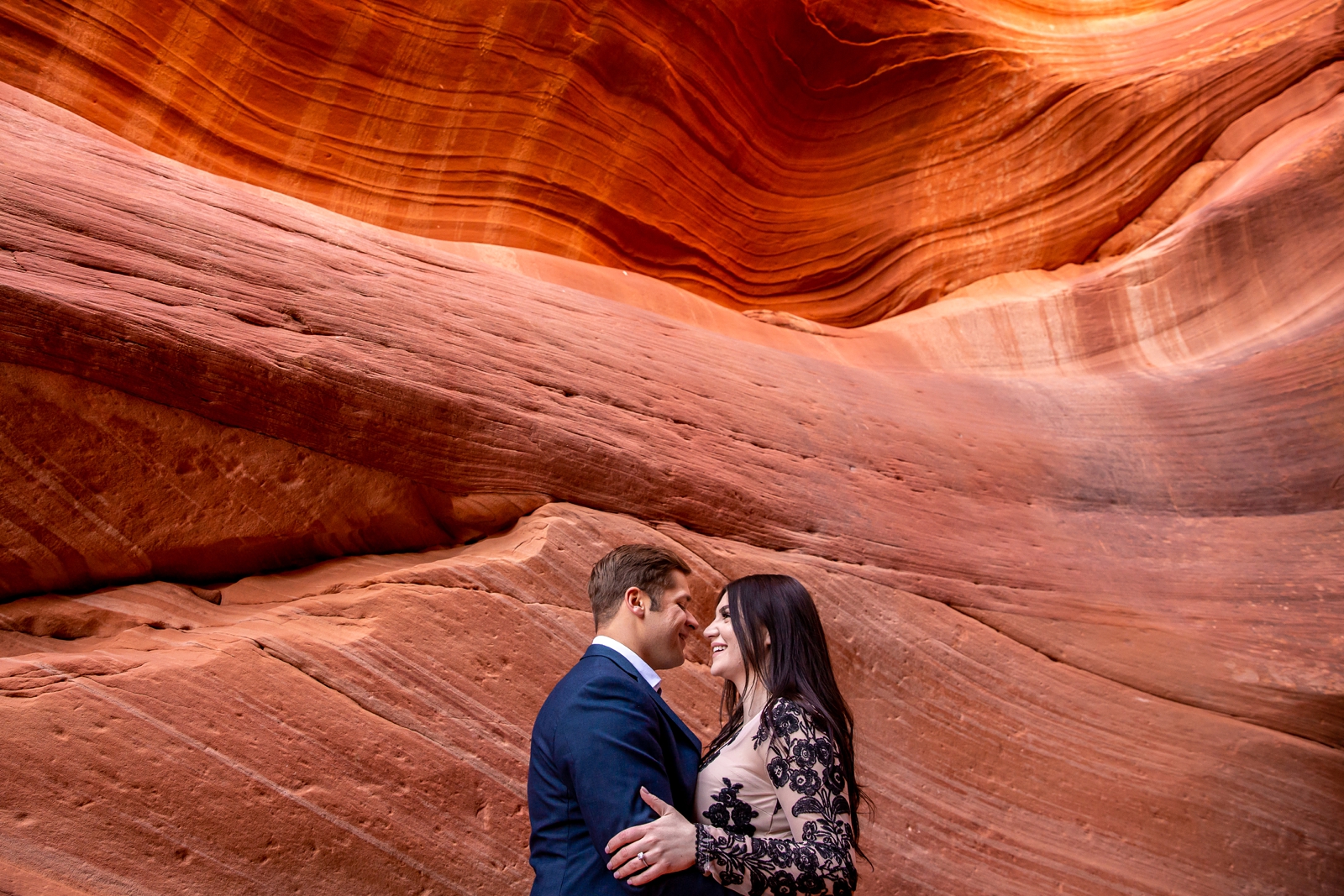 Epic engaged couple in a red rock Utah slot canyon.