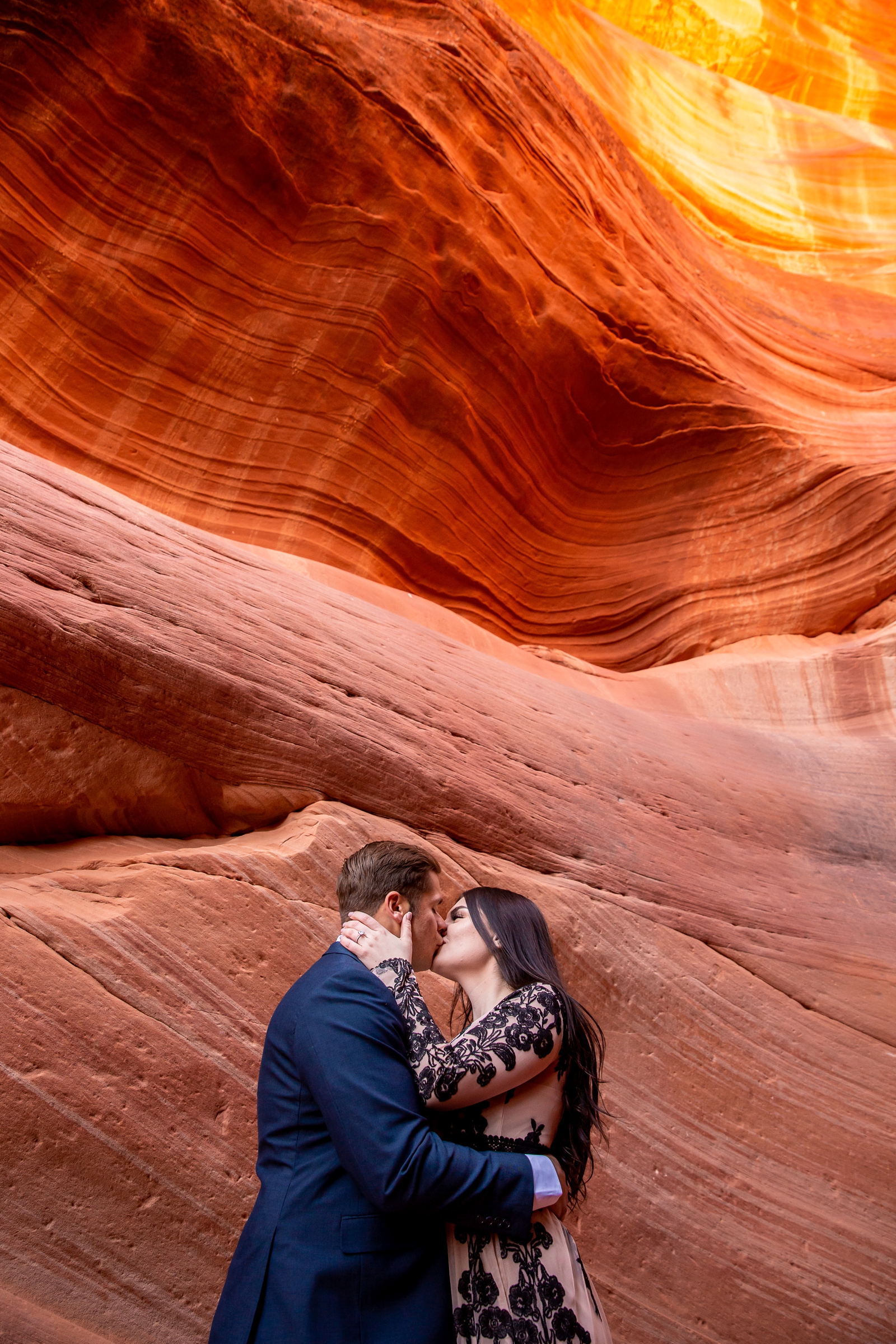 Epic kissing couple in a red rocks Utah slot canyon.