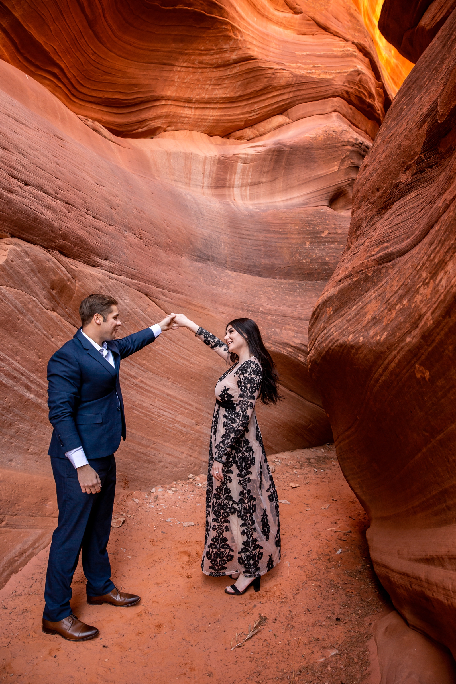 Dancing couple in a red rocks slot canyon.