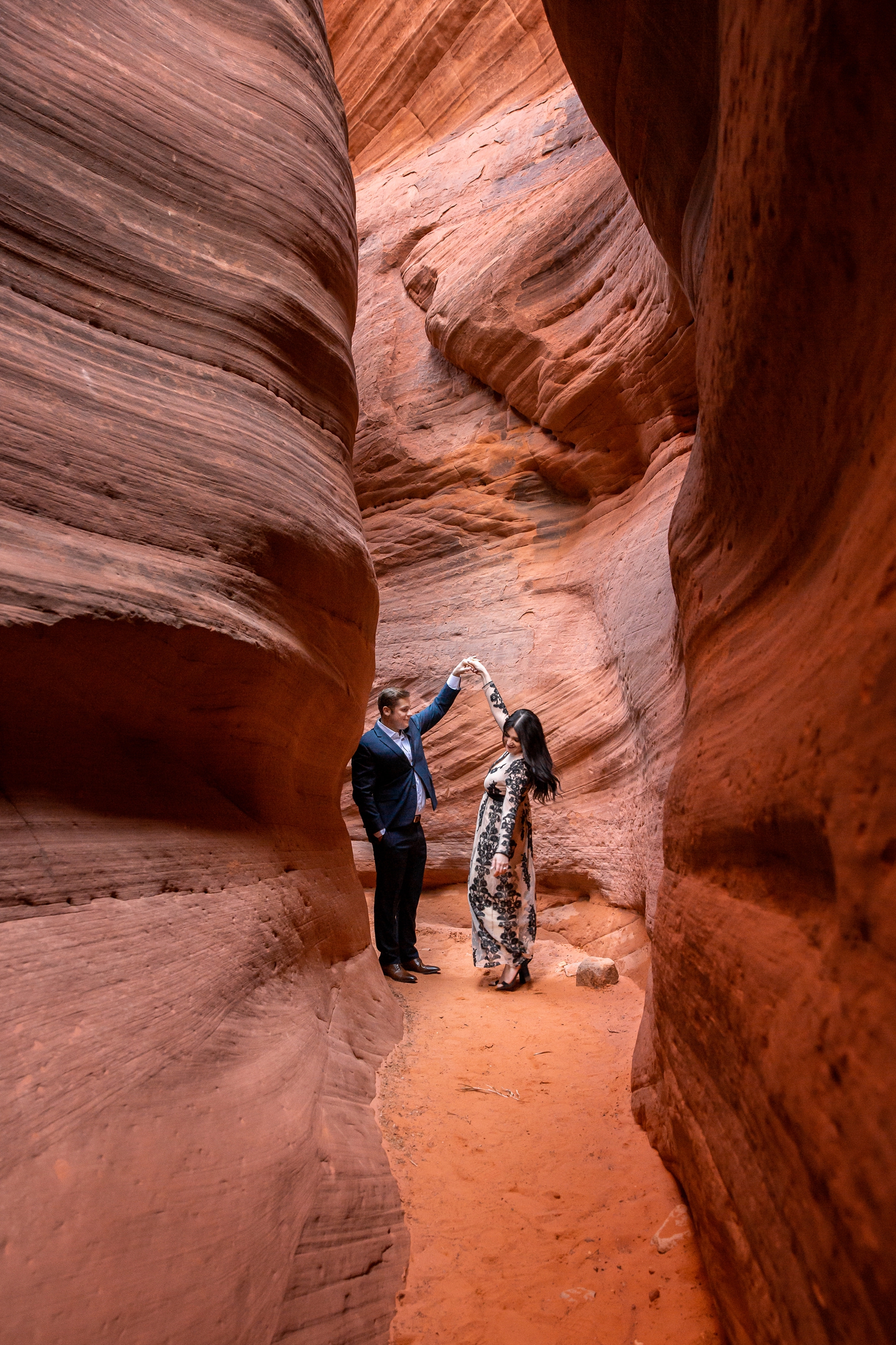 Dancing couple in a secluded red rocks slot canyon.
