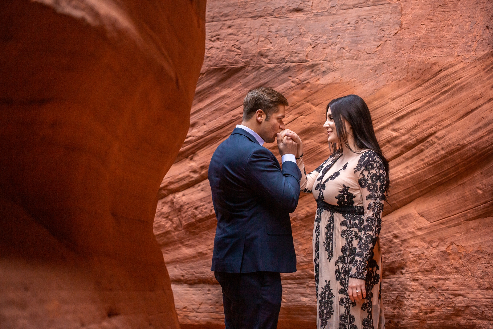 Romantic engaged couple in a UT slot canyon.