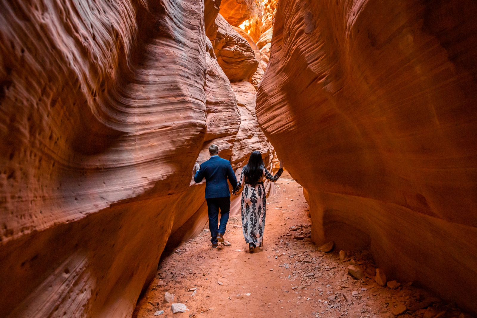 Adventurous engaged couple exploring a UT slot canyon.