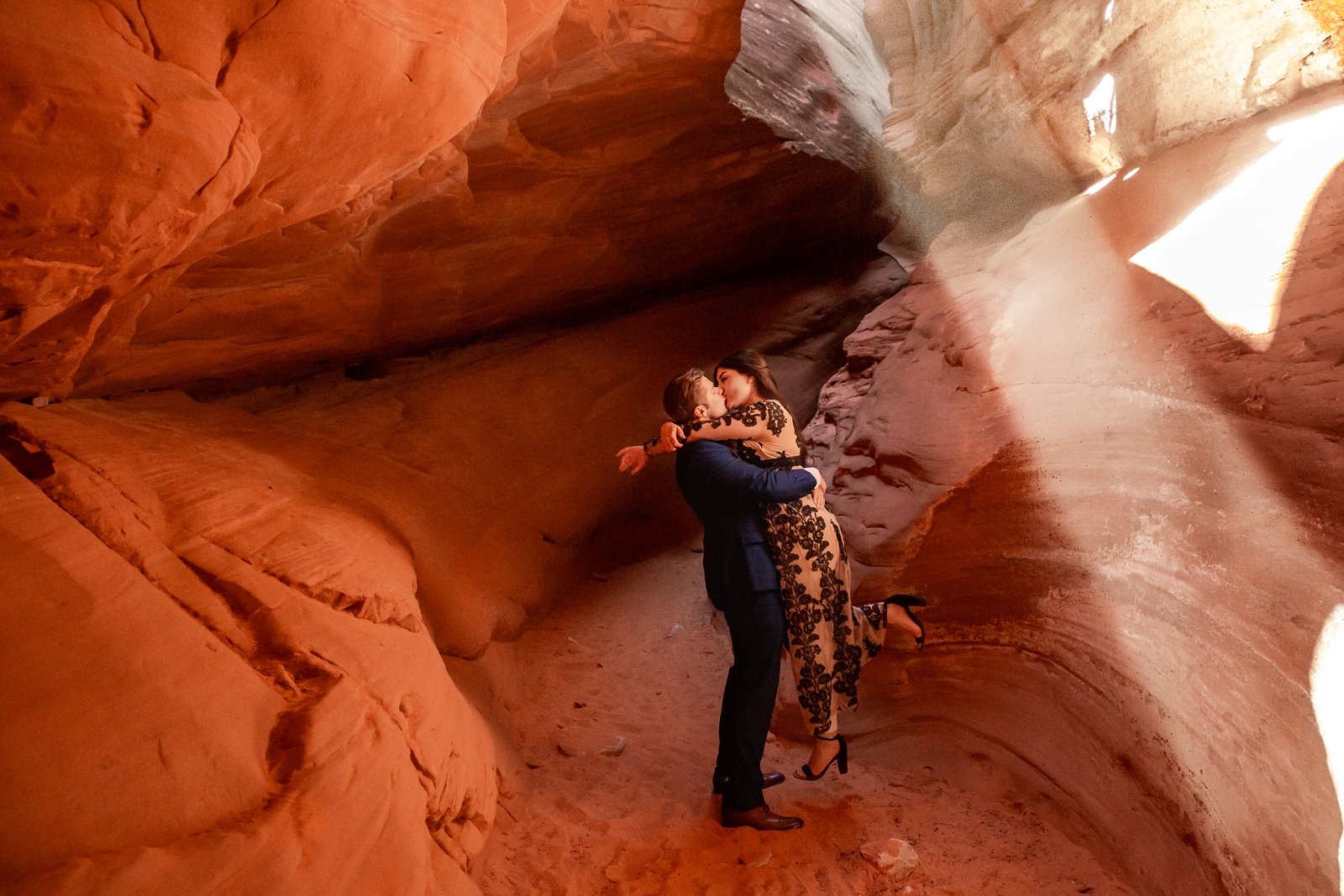 Light beams hitting the canyon floor at this couple's engagement session.