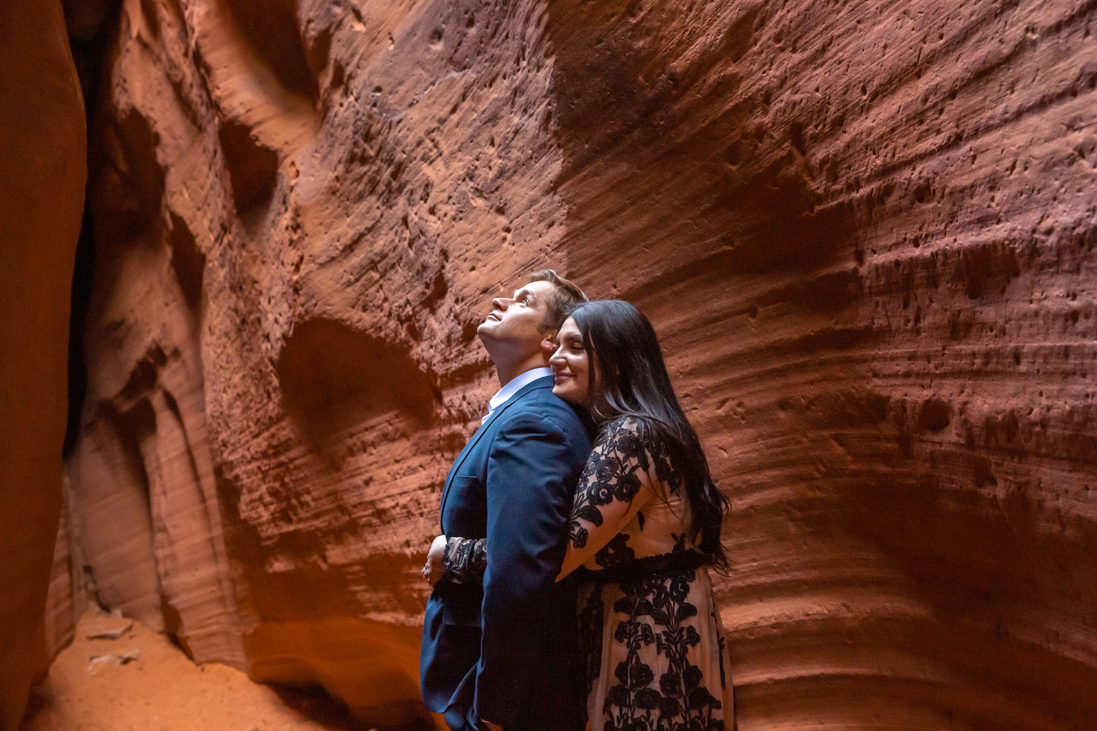 Hugging couple in a South Utah slot canyon.