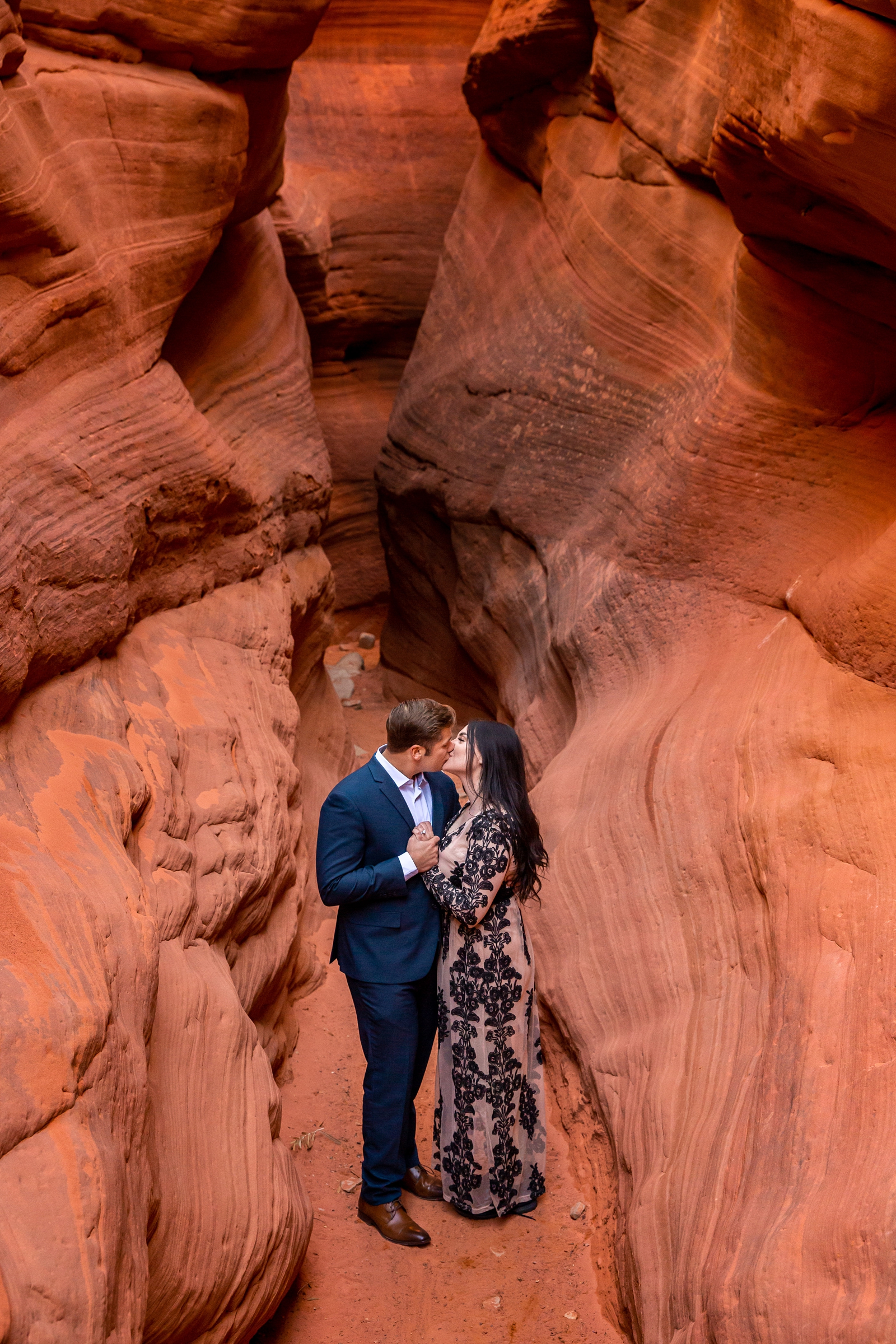 Romantic engaged couple dancing in a slot canyon near Kanab Utah.