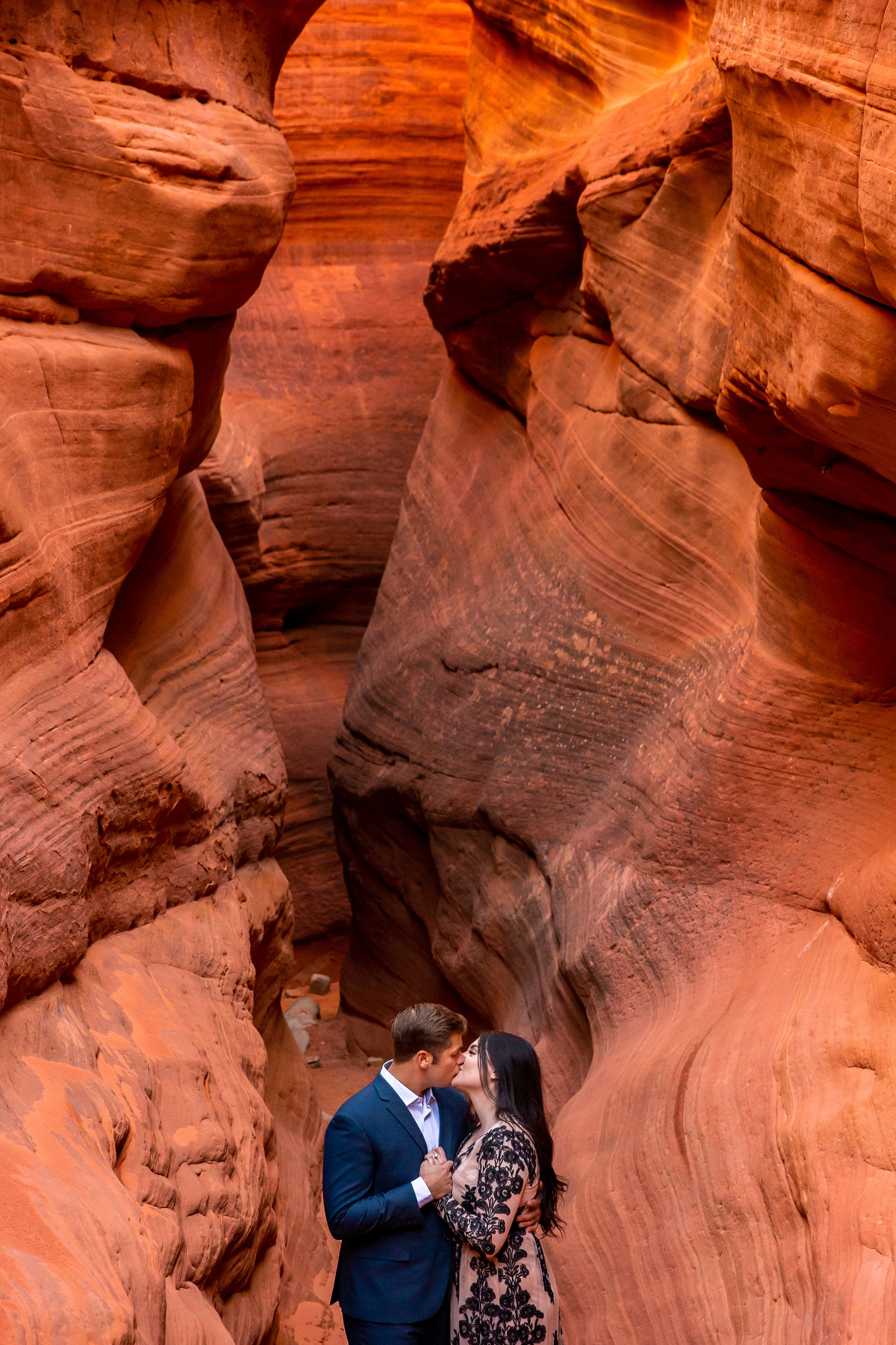 Dreamy engaged couple in a red slot canyon.