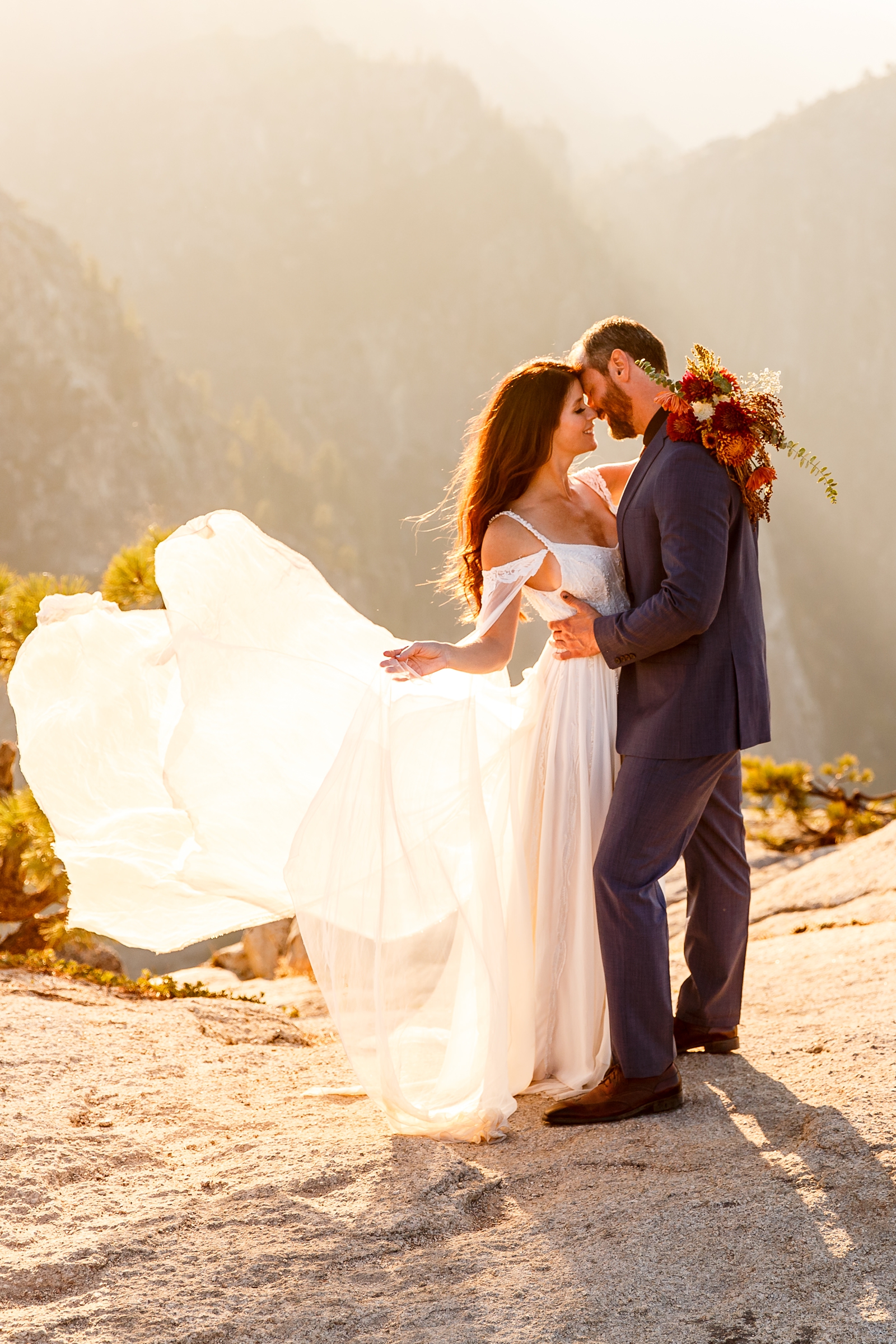 Gorgeous wedding gown fluttering in the wind at this couple's Yosemite elopement.