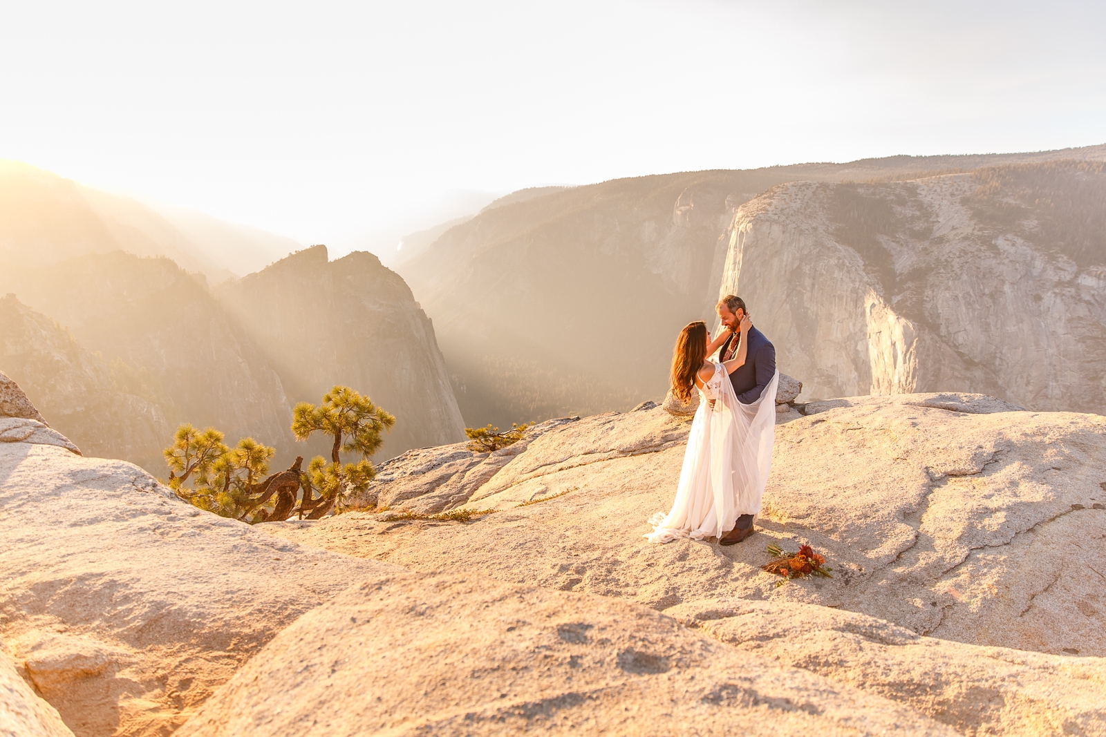 Couple dancing on a cliff during golden hour at Taft Point.