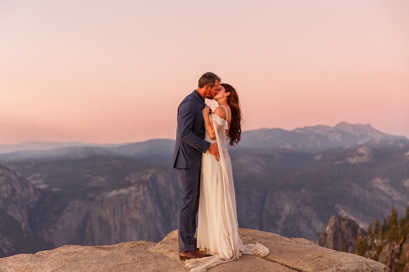 Passionate kissing couple at their pink hour Taft Point sunset elopement.