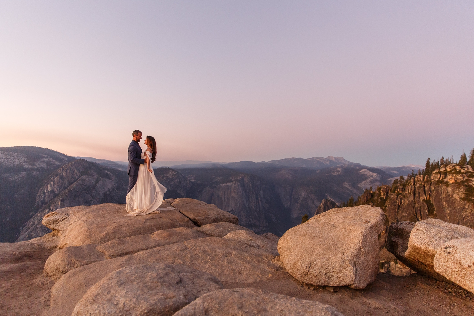 Adventurous couple eloping at Taft Point in Yosemite at sunset.