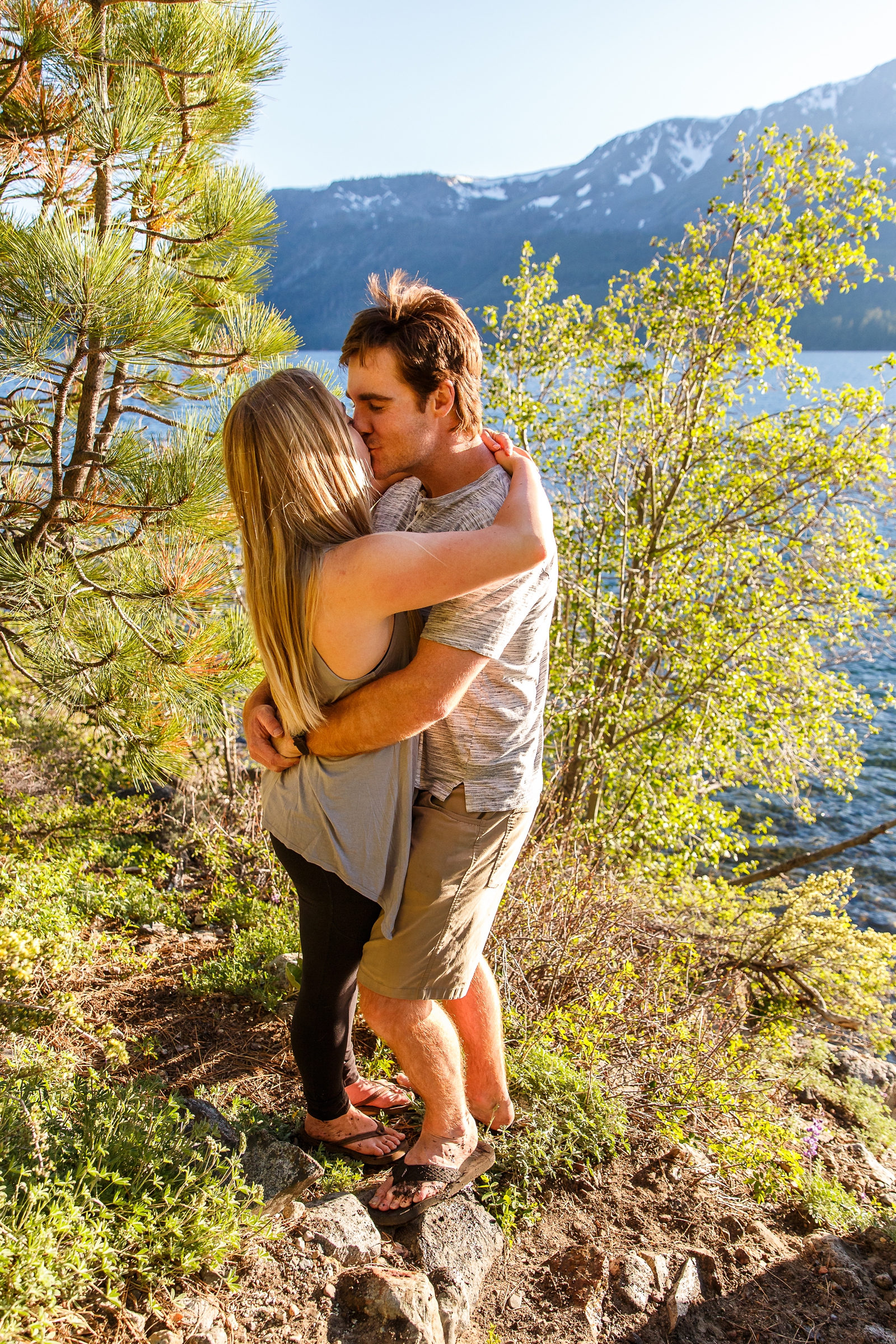 a couple kissing with the beautiful Lake Tahoe in the background during their adventure session