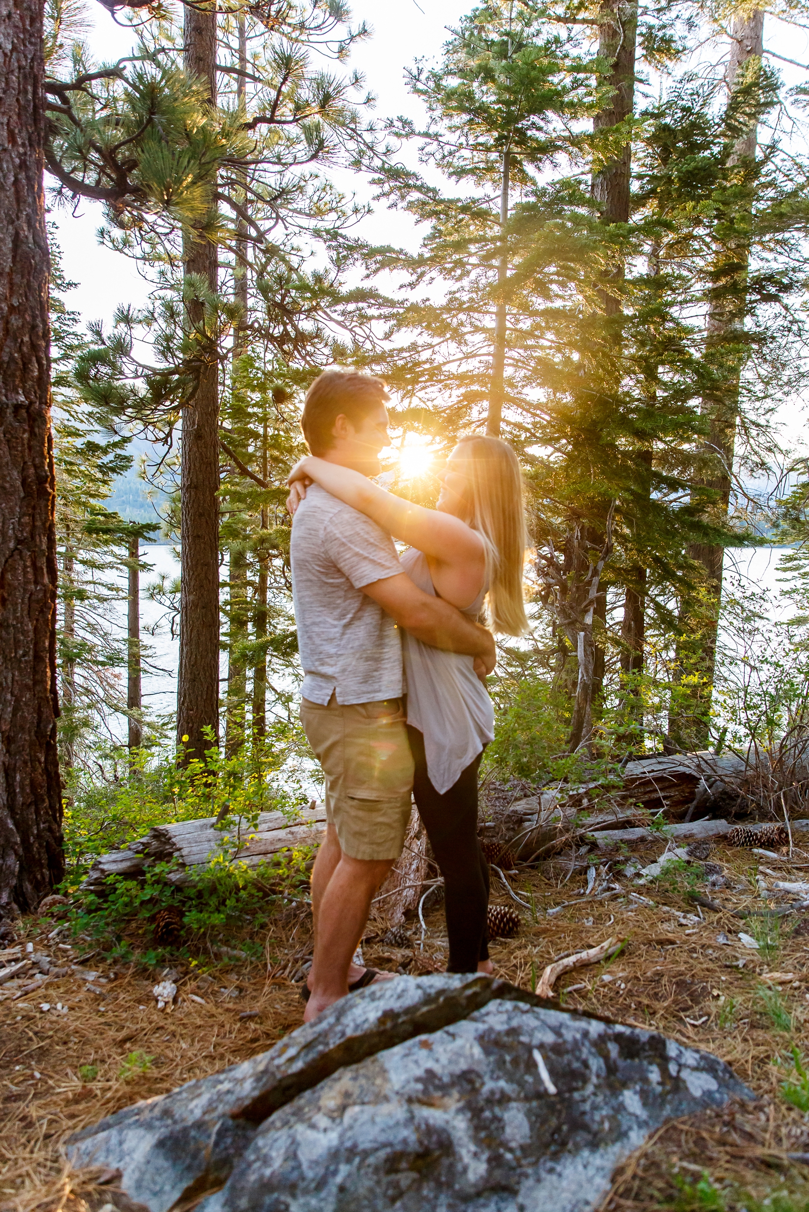 a couple looking at each other while embracing with the sunset over Lake Tahoe in the background during their Tahoe area adventure session