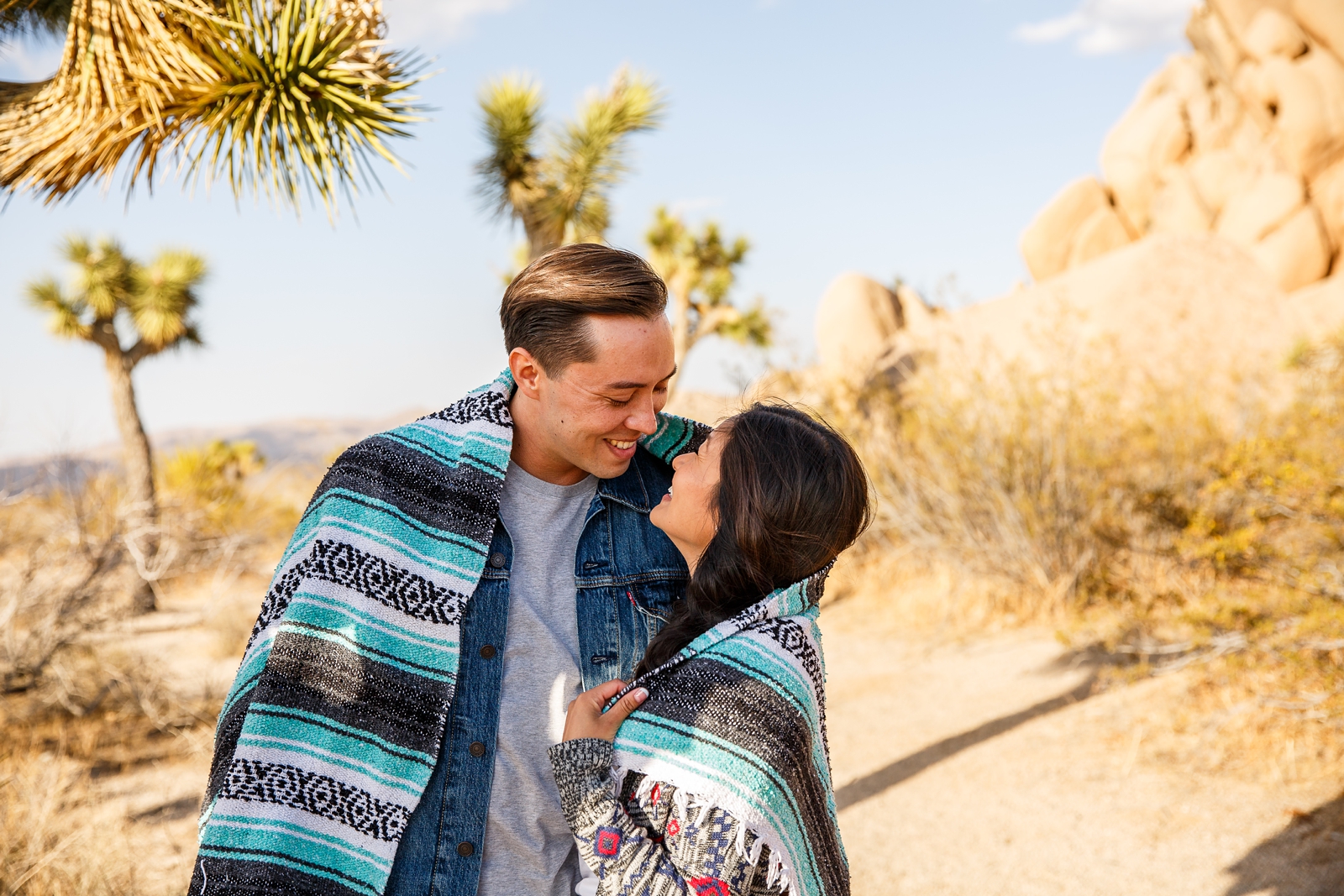 Engaged couple about to kiss in Joshua Tree NP, CA.
