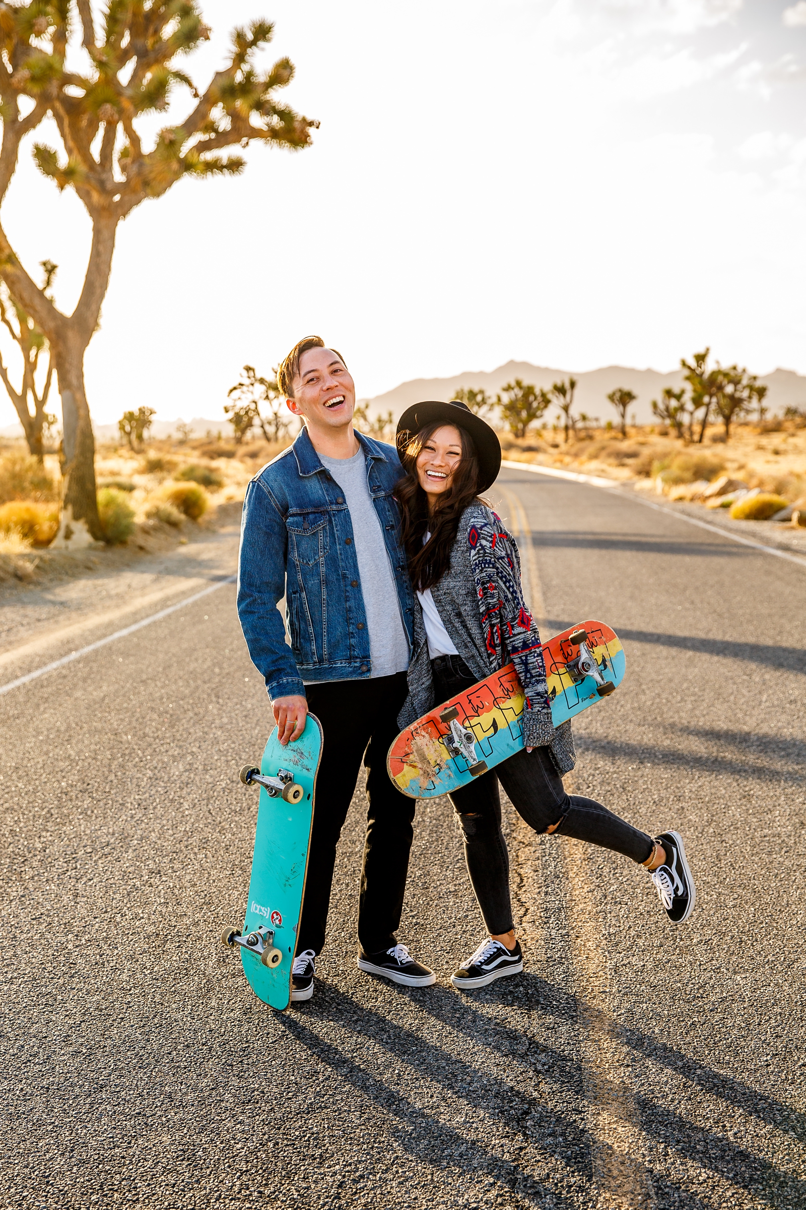 Engaged skateboarding couple in Joshua Tree National Park.