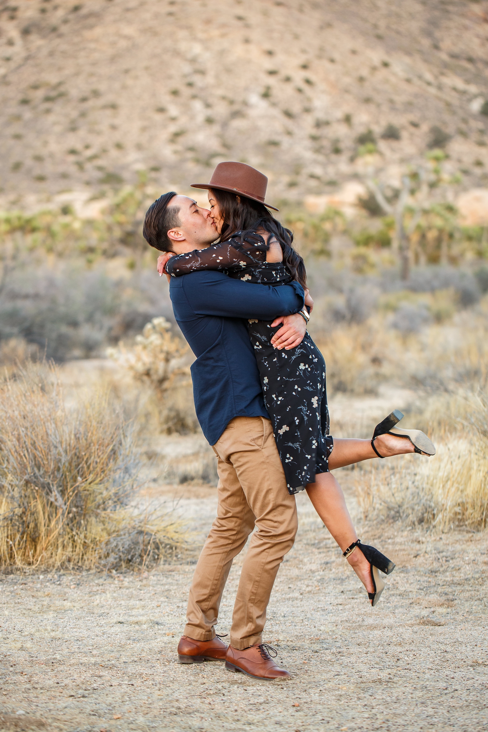 Twirling kiss at this couple's desert engagement session.