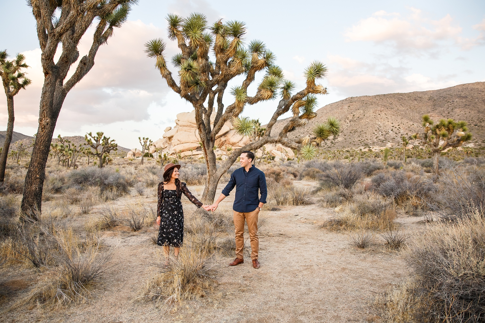 Whimsical engaged couple in the desert at Joshua Tree. 