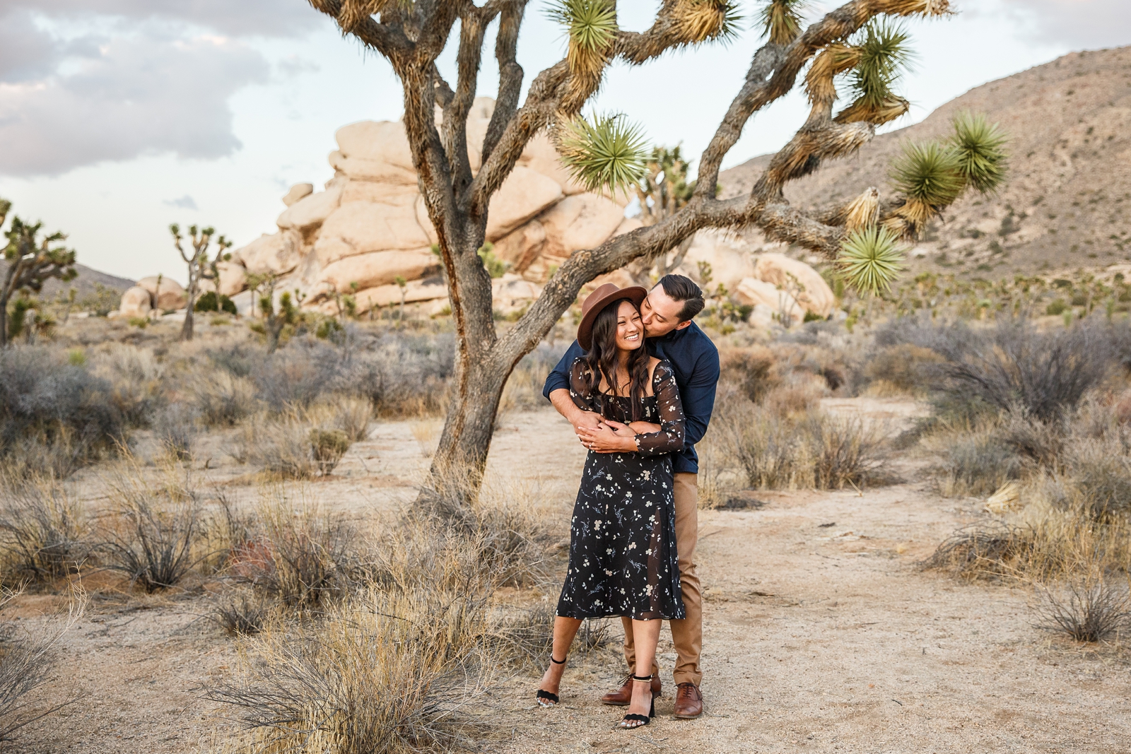 Adorable kiss at this couple's Joshua Tree engagement.