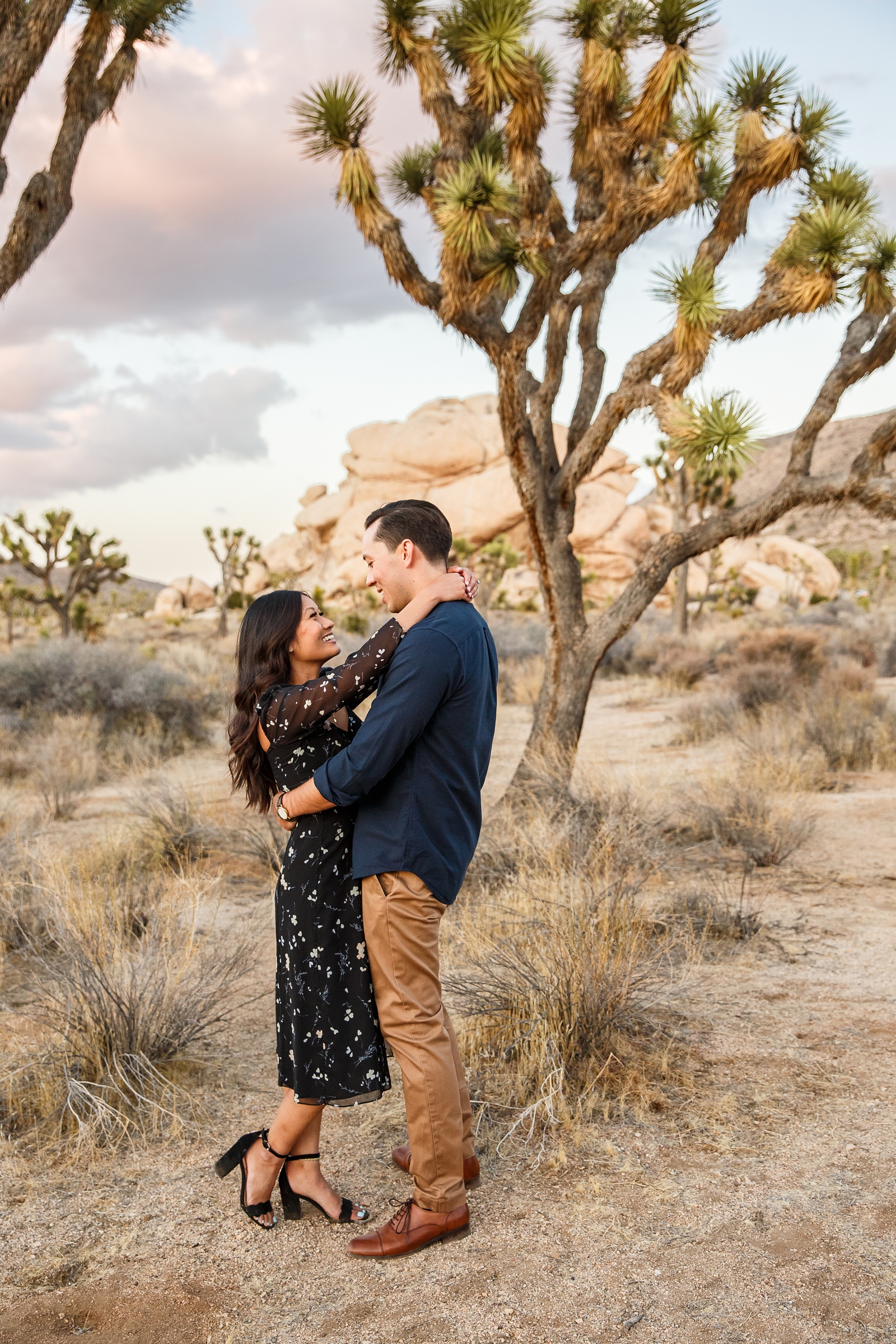 Engaged couple in Joshua Tree NP at sunset. 