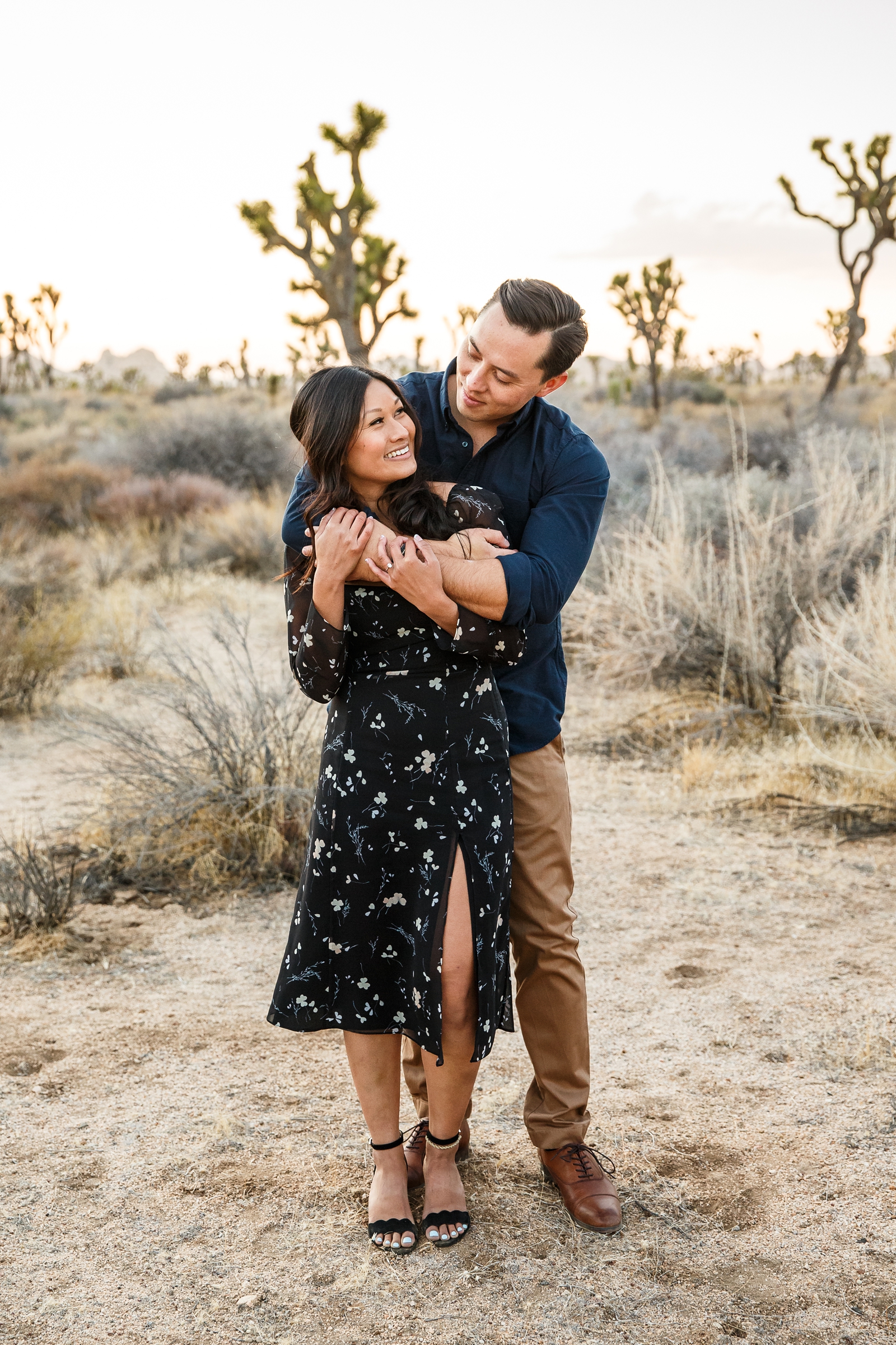 Engaged couple laughing in Joshua Tree NP.