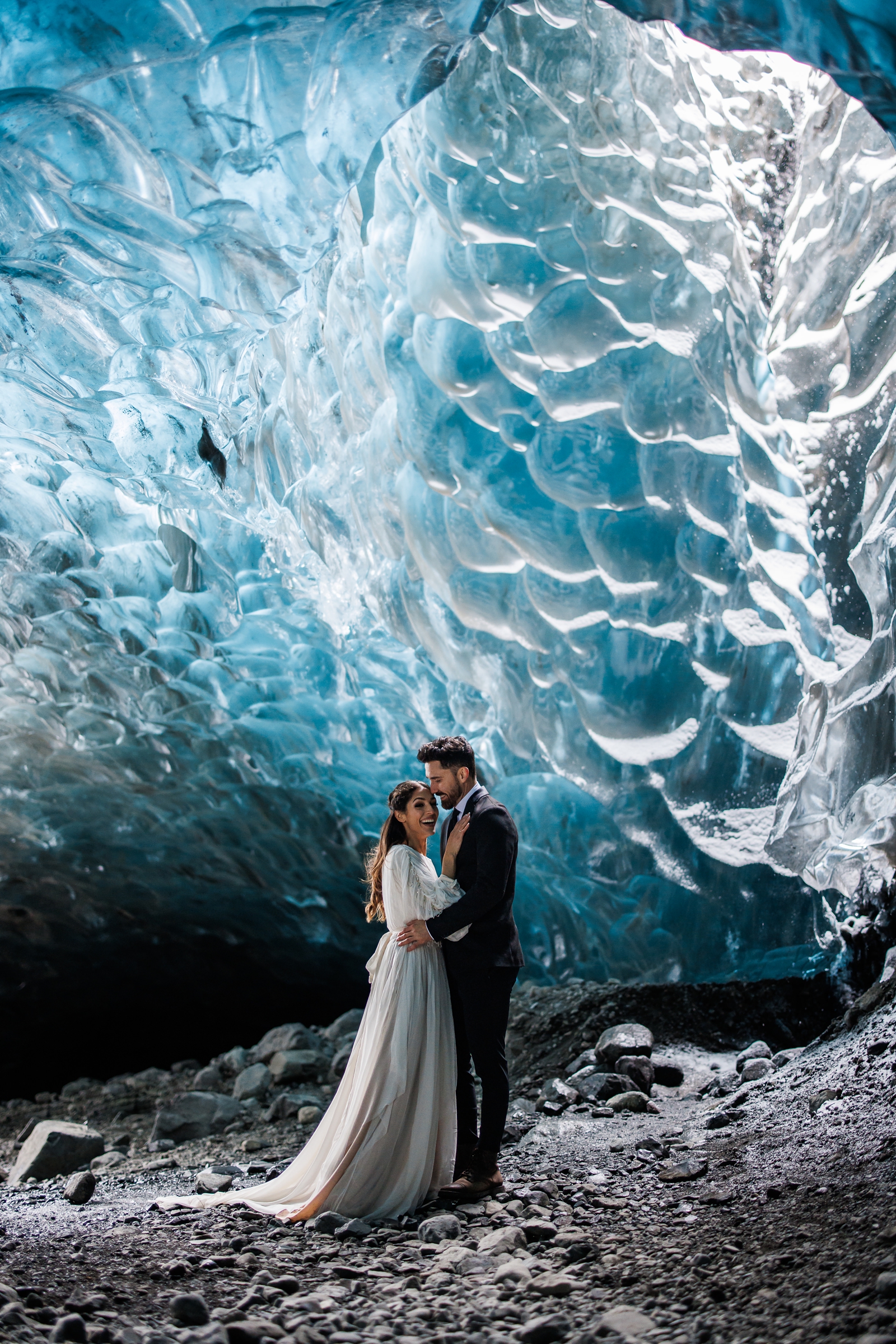 An eloping couple laughs in an ice cave near Jökulsárlón Iceland