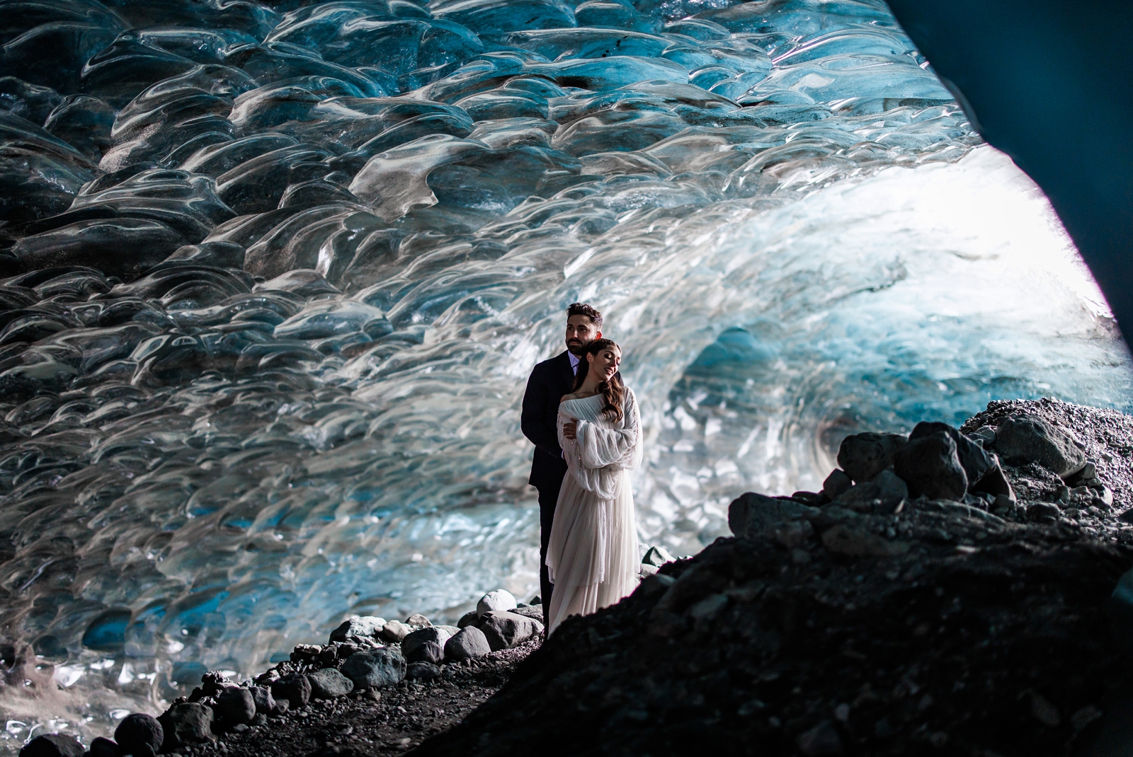 This eloping couple shares a tender moment in a magical Iceland ice cave.