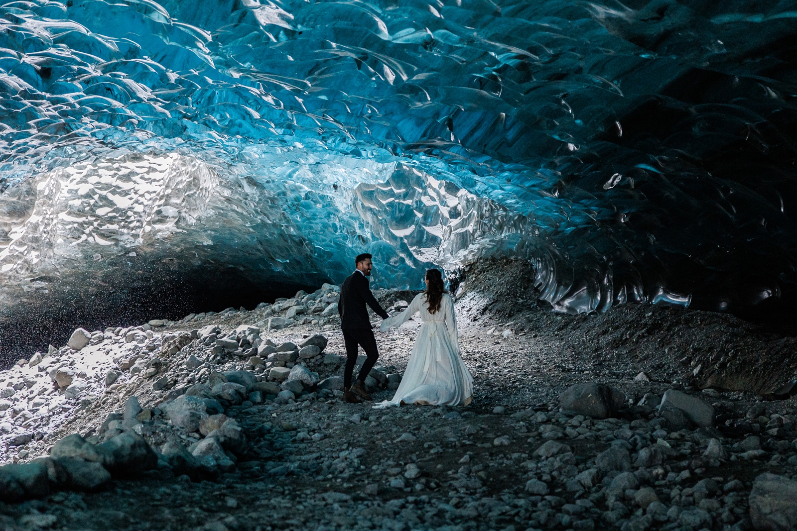 A couple walks through a magical Iceland ice cave on their wedding day.