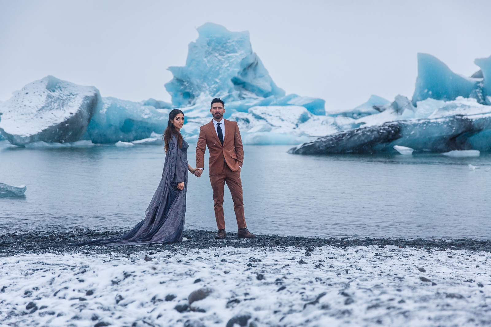 Nontraditional eloping couple braving the cold during their winter Iceland elopement.