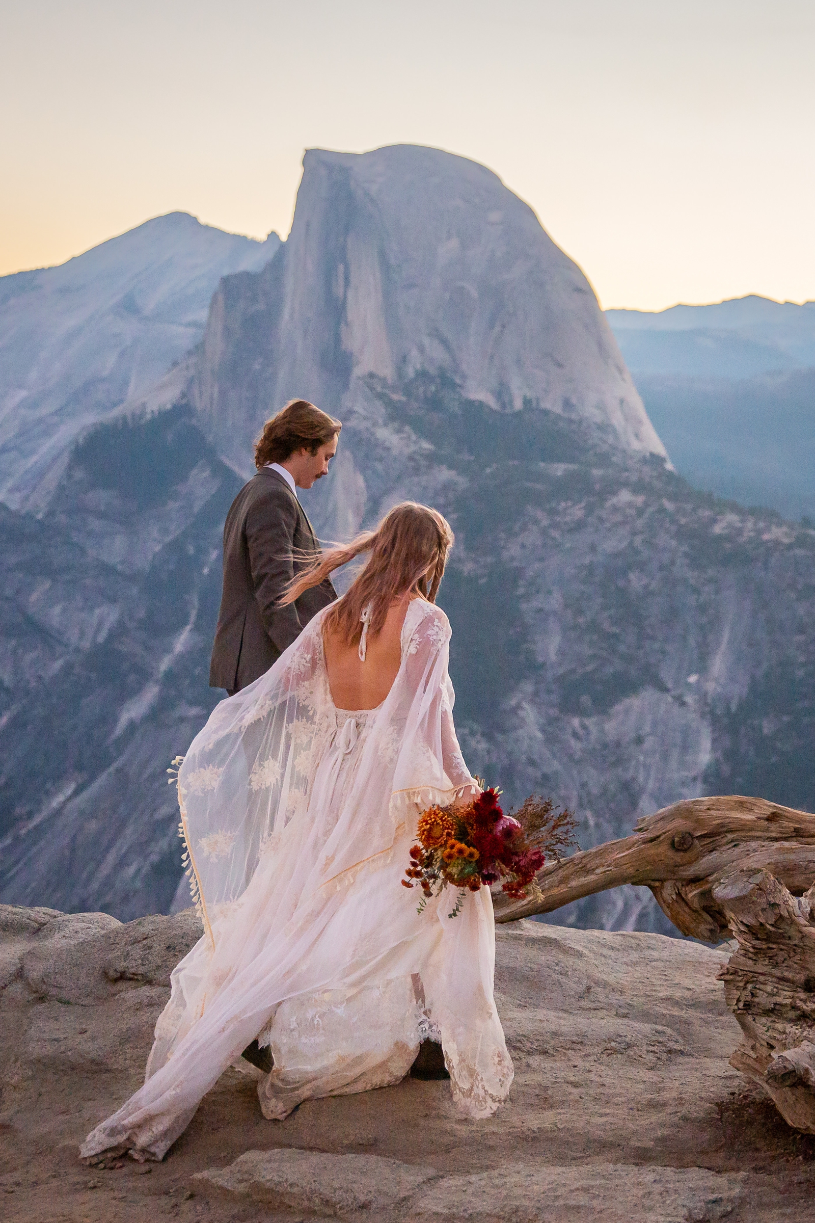 Half Dome in the background of this couple's adventurous Glacier Point elopement in Yosemite.