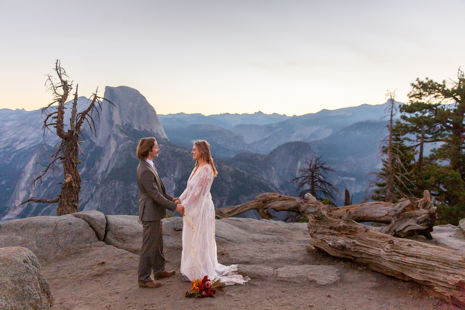 A couple exchanges vows during their Yosemite sunrise Glacier Point elopement. 