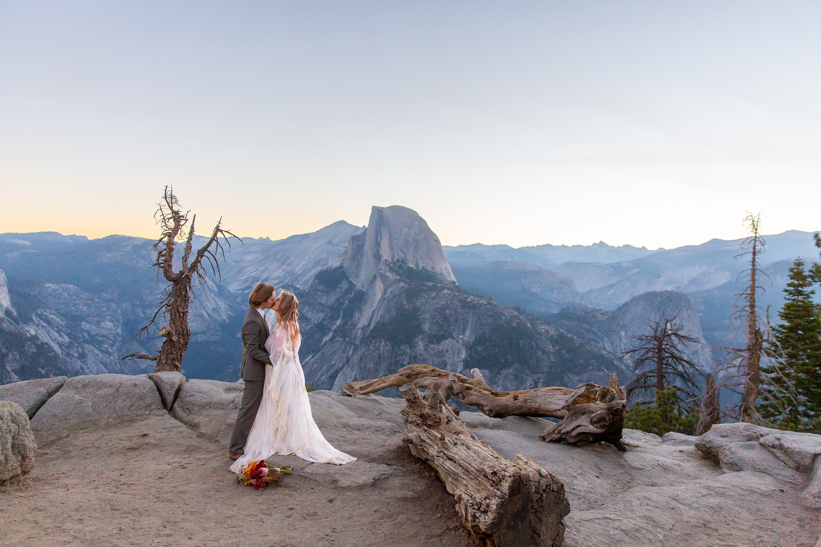 First kiss of this eloping couple in Yosemite by Half Dome.