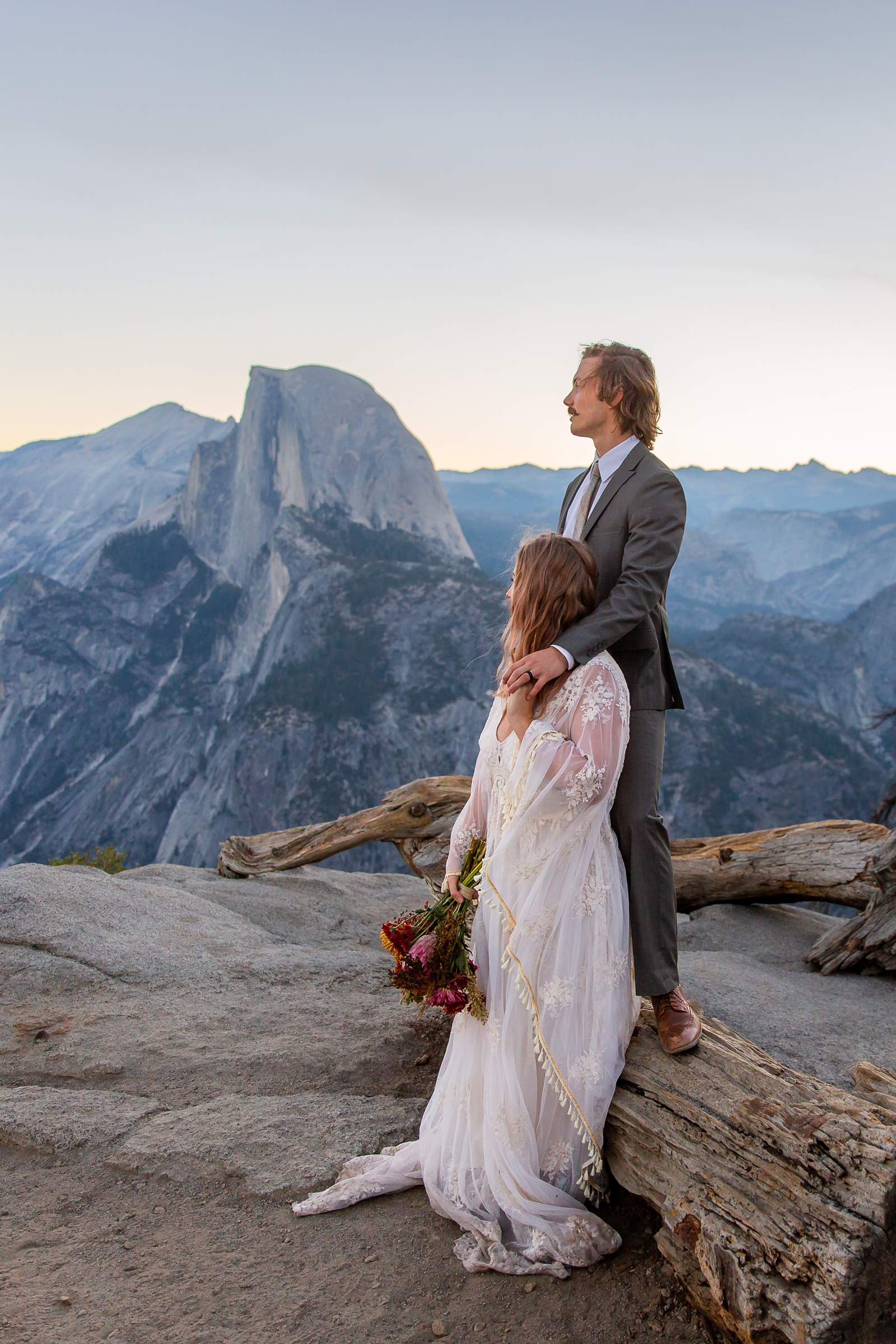 Wistful couple just eloped at Glacier Point in Yosemite.