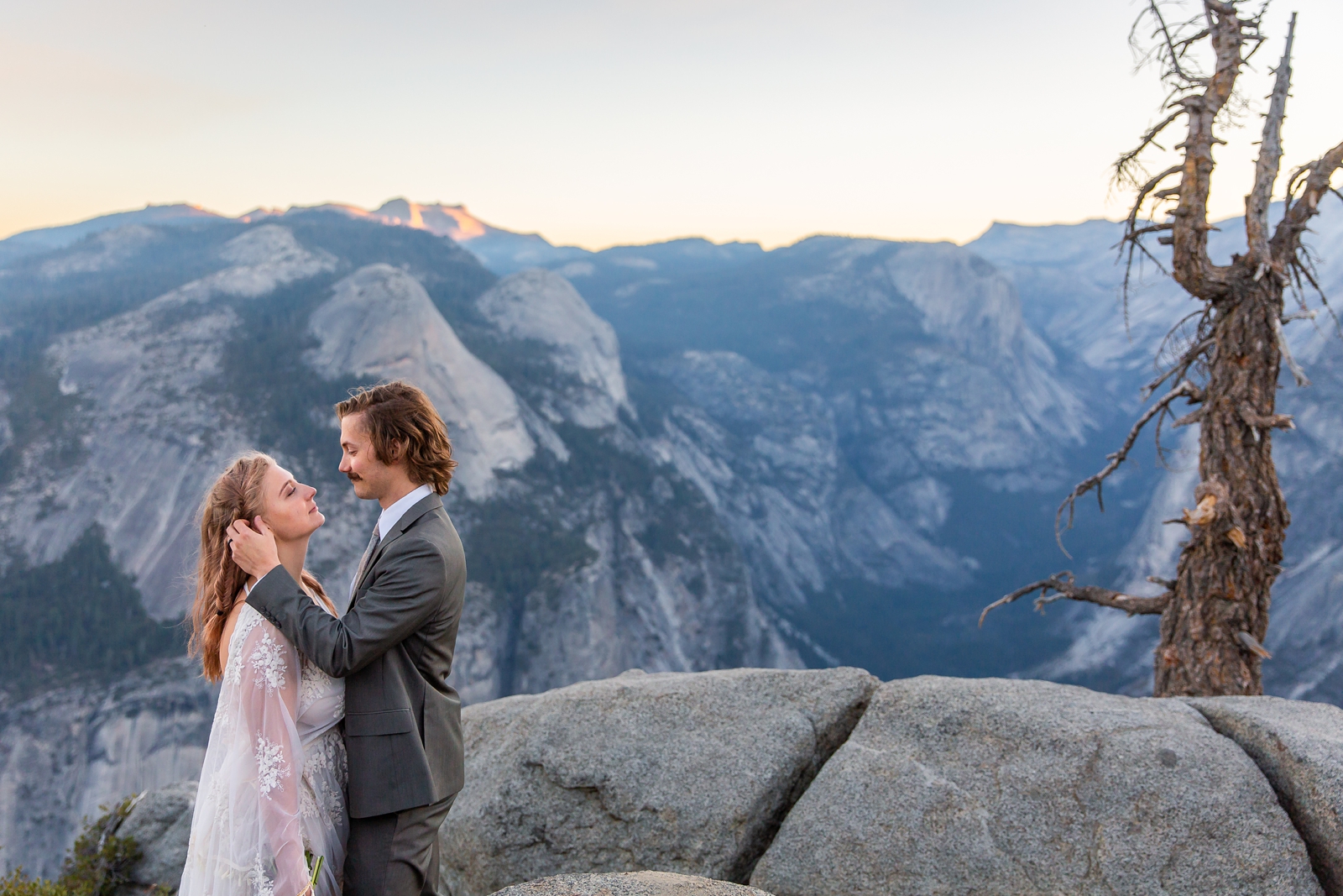 Tender caresses at this couple's Yosemite sunrise Glacier Point elopement.
