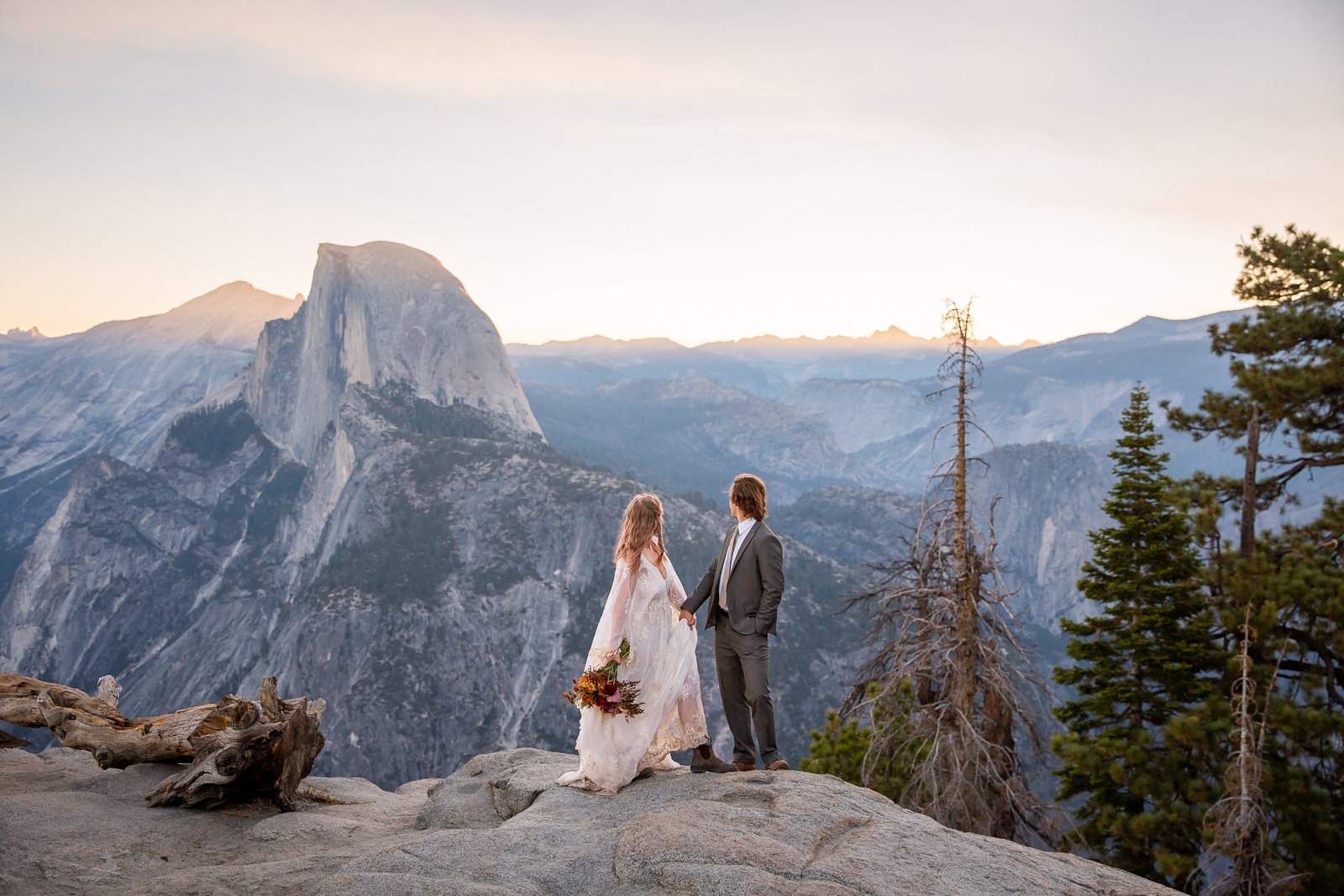 Eloping couple taking in the view of Half Dome in Yosemite.