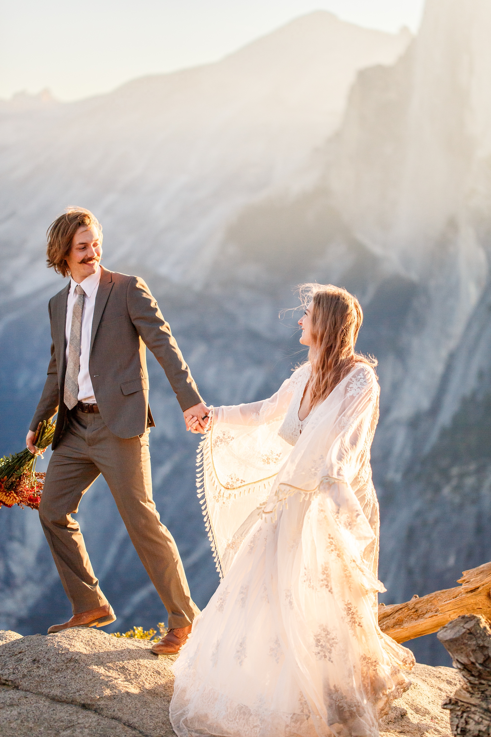 Laughing bride and groom hiking in Yosemite.
