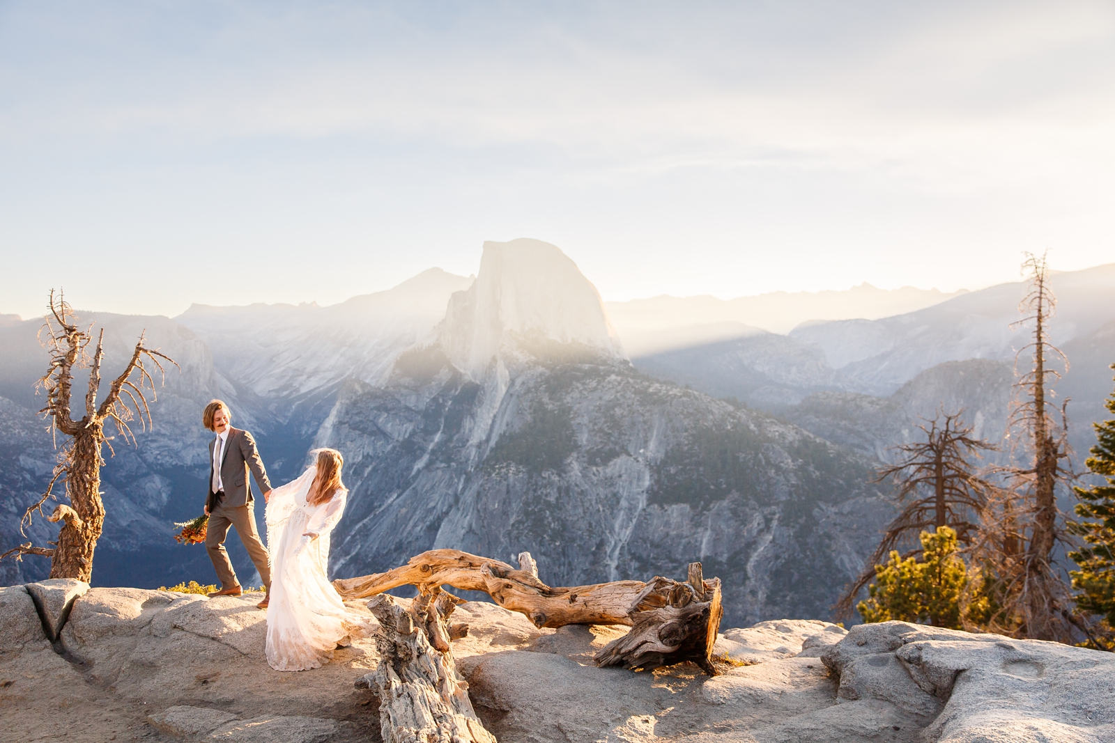 Adventurous couple hiking in Yosemite on their wedding day.