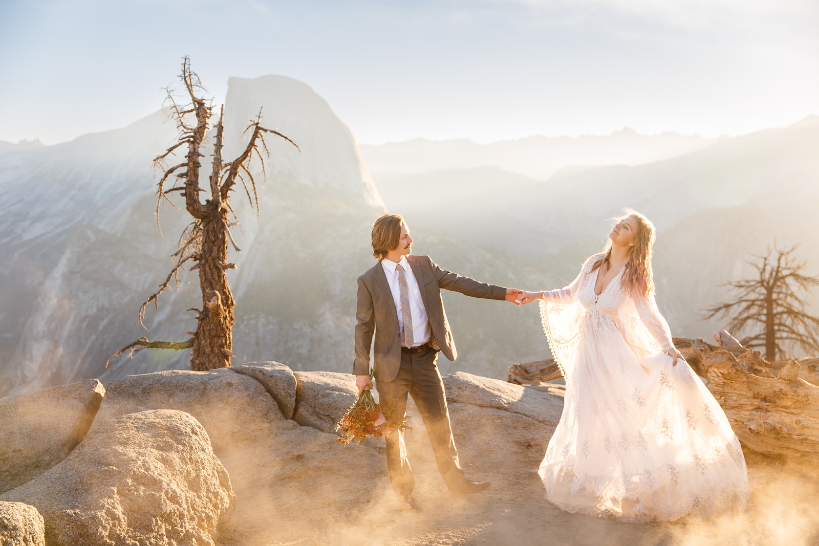 Adventurous couple dancing during their Yosemite golden hour Glacier Point elopement.