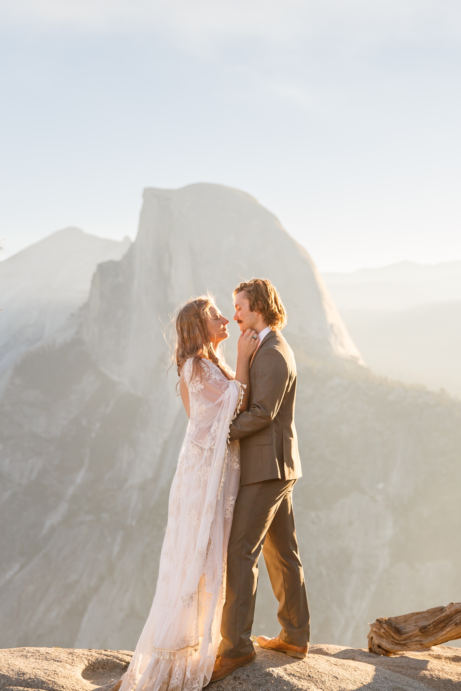 Adventurous couple eloping in front of Half Dome in Yosemite National Park.