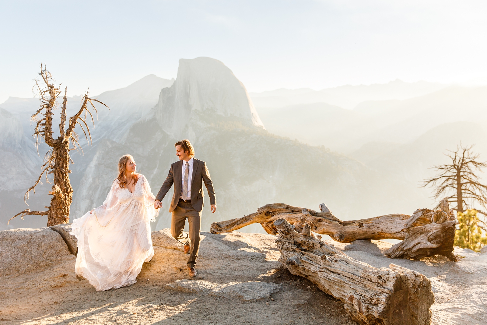 Bride and groom hiking at Glacier Point Yosemite.