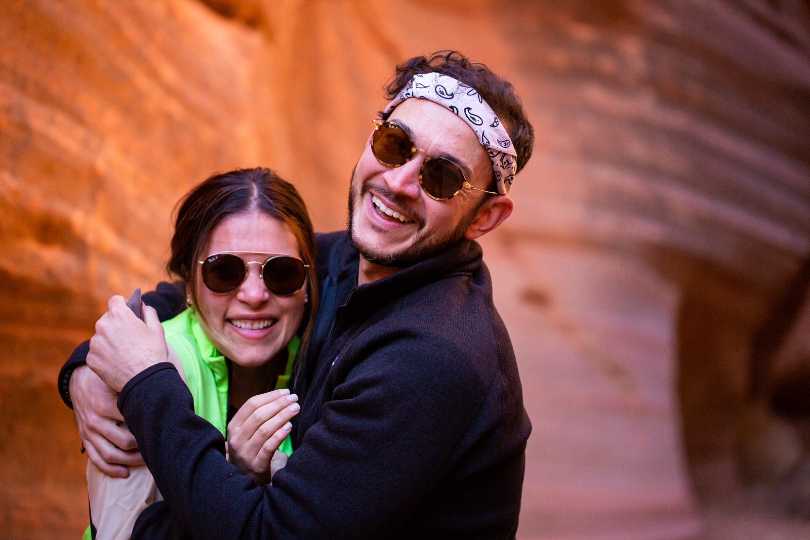 a newly engaged couple embracing after their surprise proposal in the Utah slot canyon during the adventurous hike